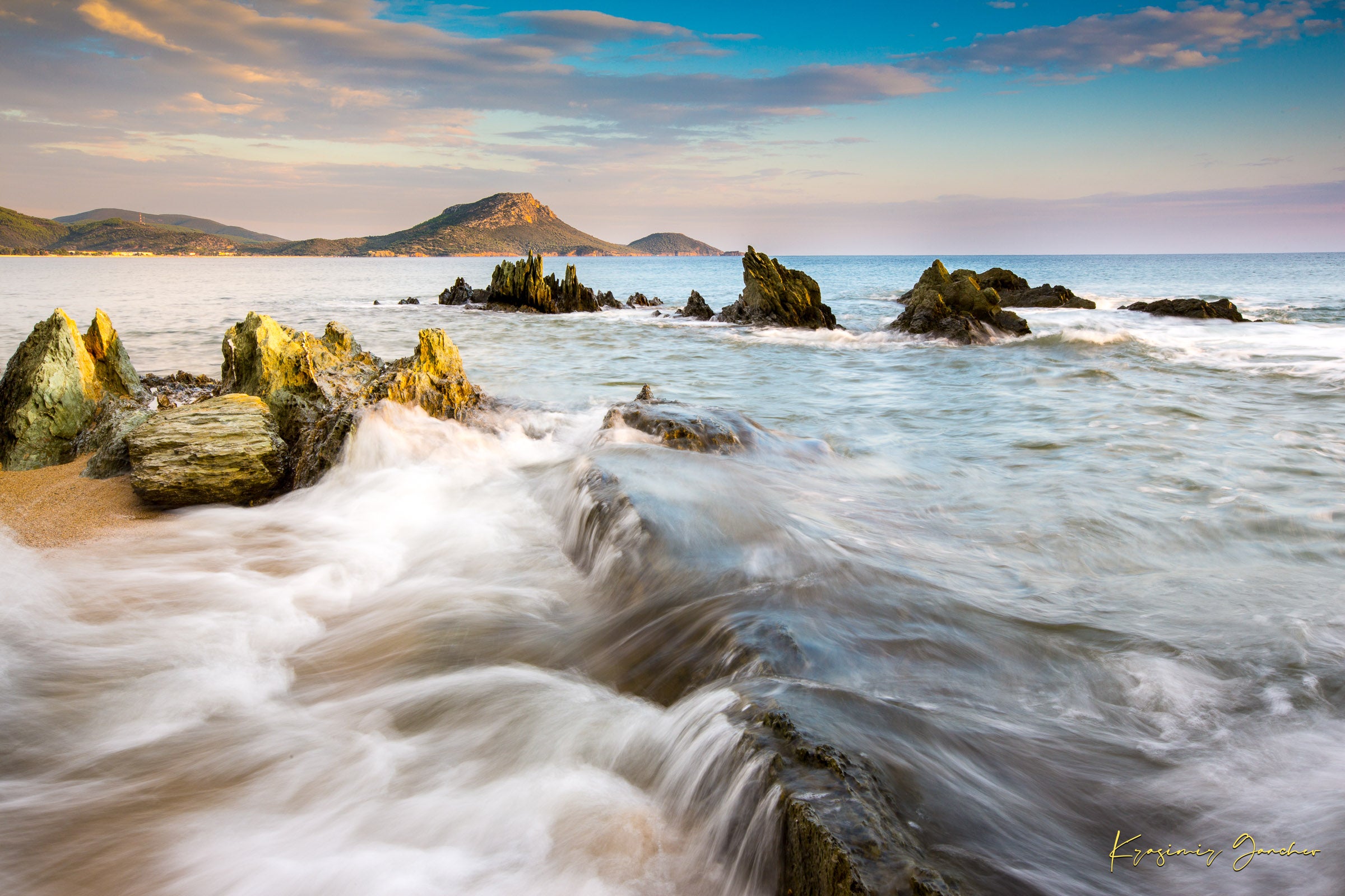 Sunset view of Sithonia's coastline featuring sea, rocky beach, scattered boulders, and gentle waves. #Finish_Acrylic Recess