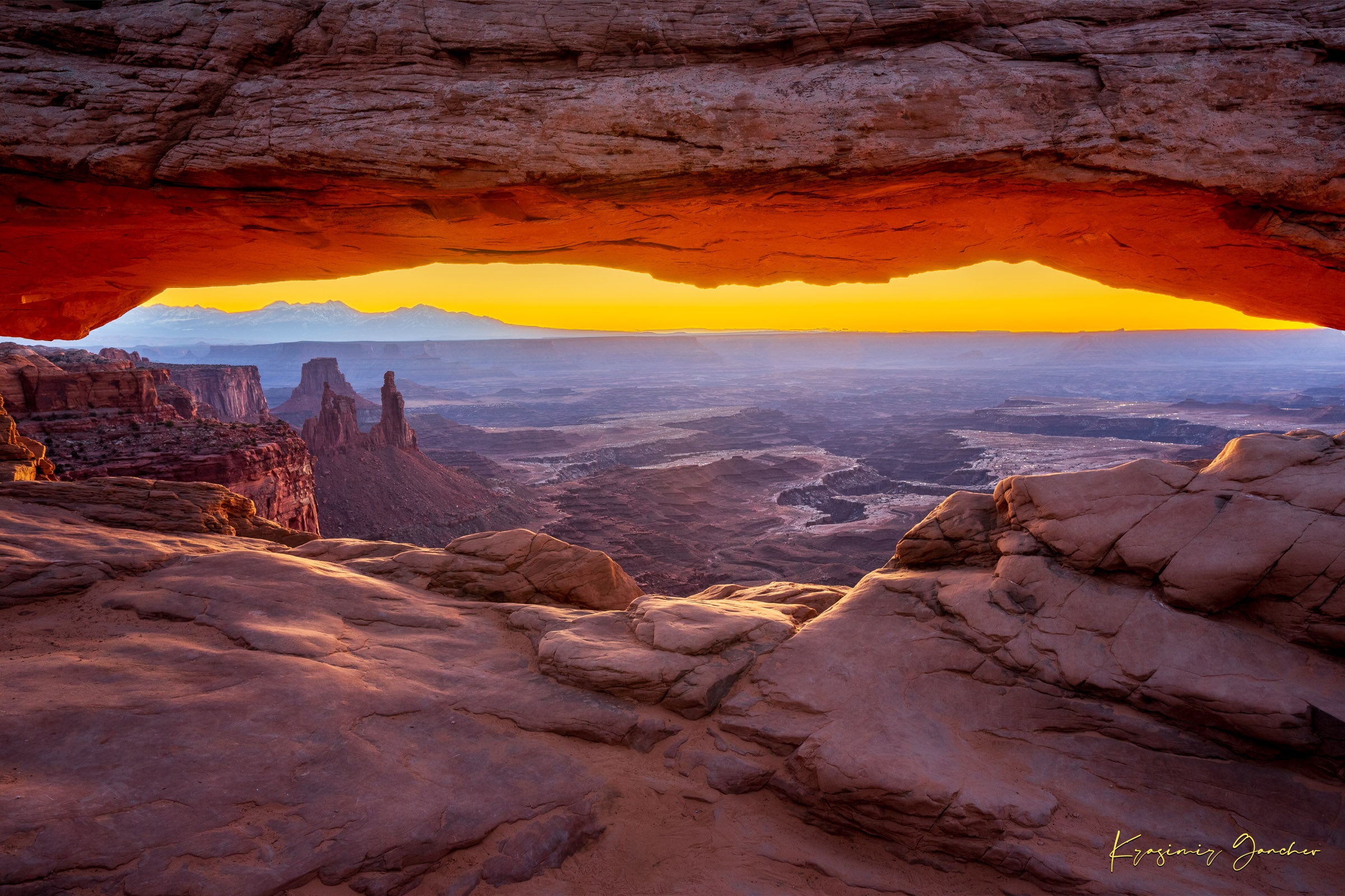 Mesa Arch in Canyonlands National Park framing a sunrise horizon under hazy skies, with golden rays illuminating rock formations. #Finish_Acrylic Recess