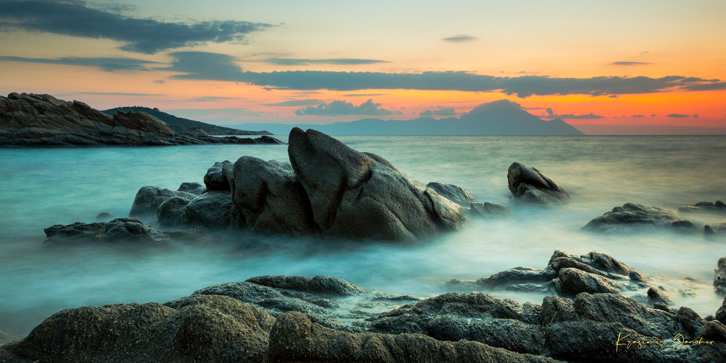 Sunrise long exposure at Sarti featuring coastal rock formations, sea stacks, cloud-covered sky, and soft waves. #Finish_Acrylic Recess