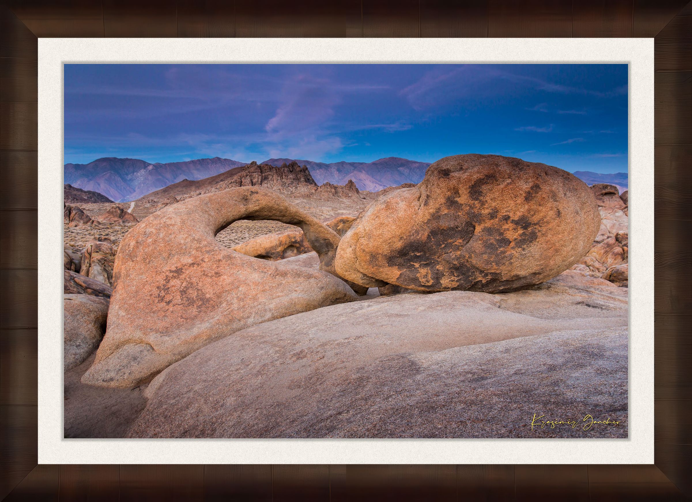 Natural sandstone arch standing against a dusky sky with scattered clouds and dry terrain in Inyo National Forest. #Finish_Roma Cigar Leaf Frame & Bright Liner