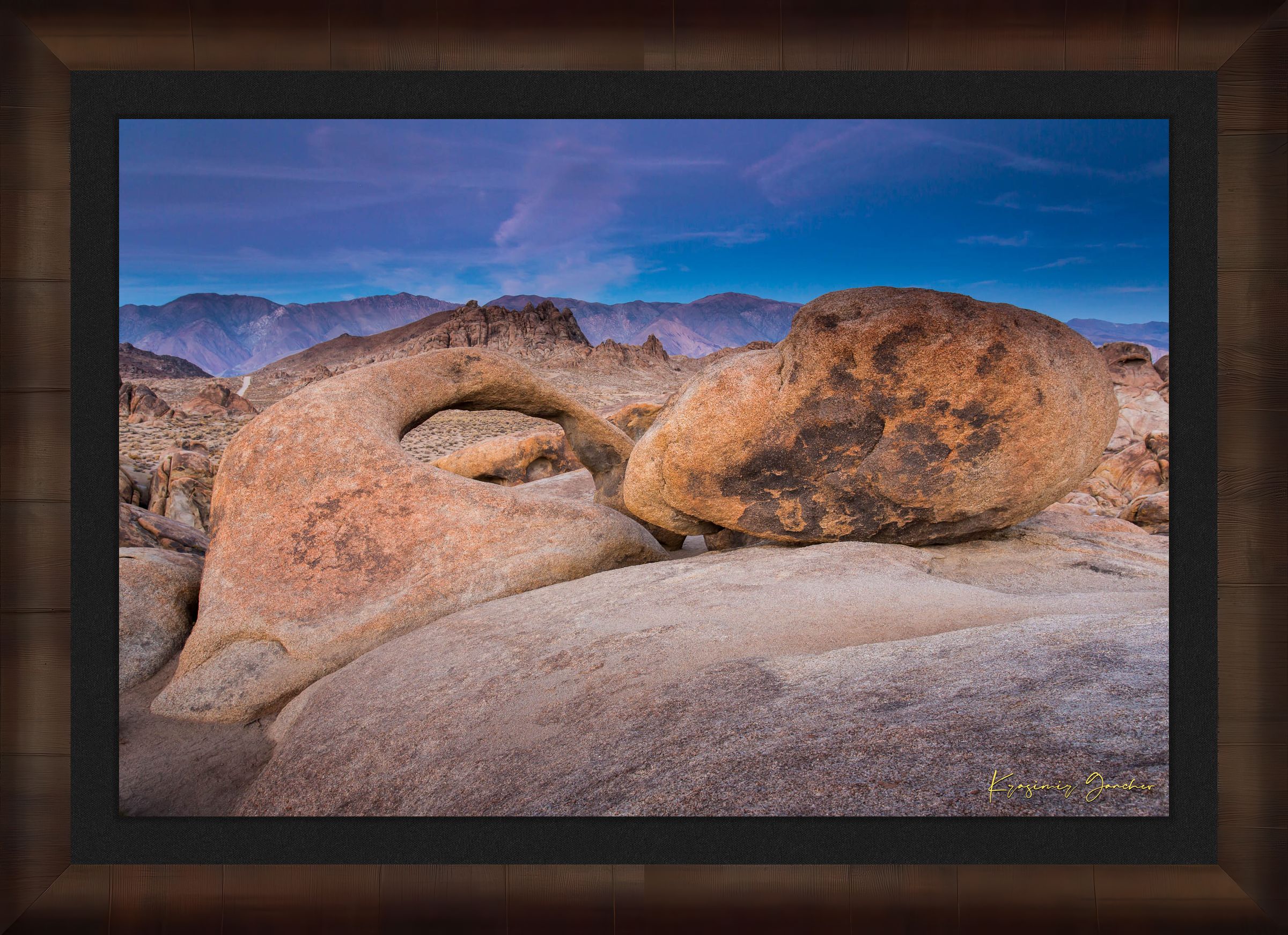 Natural sandstone arch standing against a dusky sky with scattered clouds and dry terrain in Inyo National Forest. #Finish_Roma Cigar Leaf Frame & Dark Liner