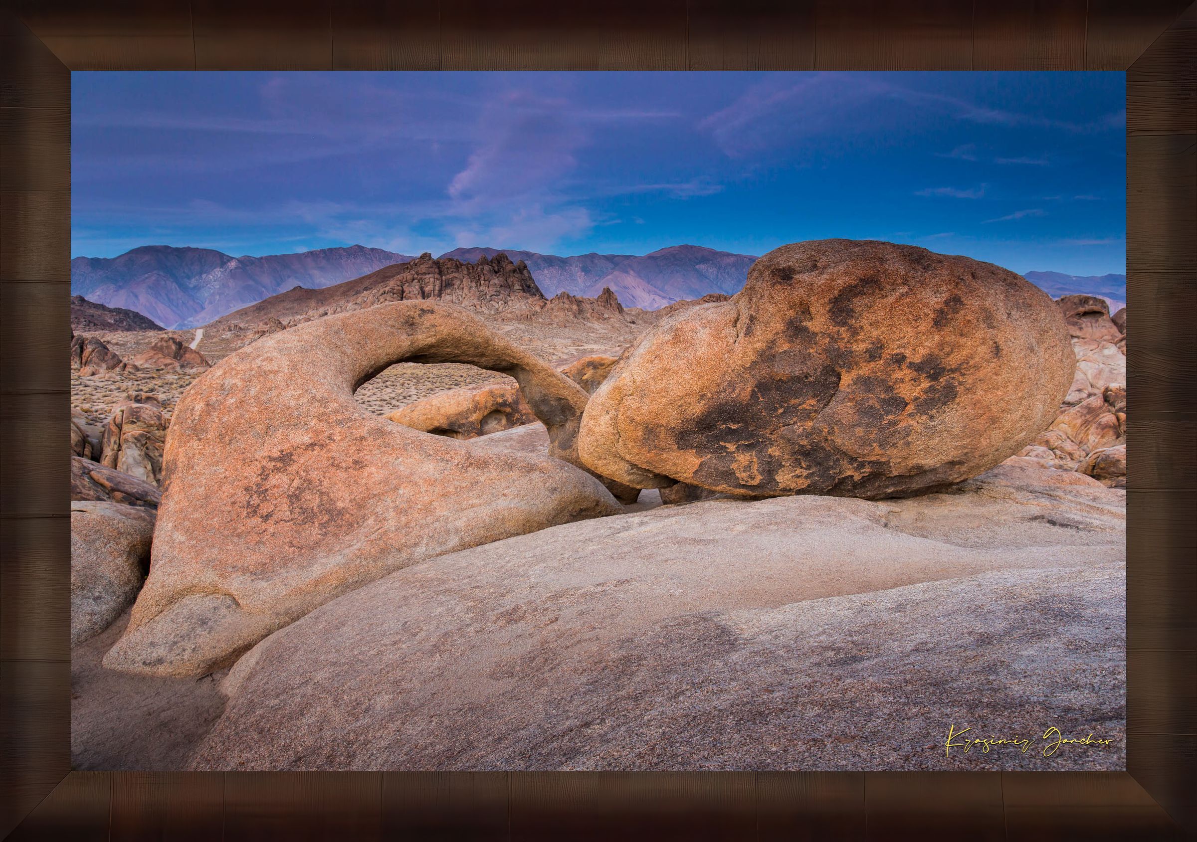 Natural sandstone arch standing against a dusky sky with scattered clouds and dry terrain in Inyo National Forest. #Finish_Roma Cigar Leaf Frame