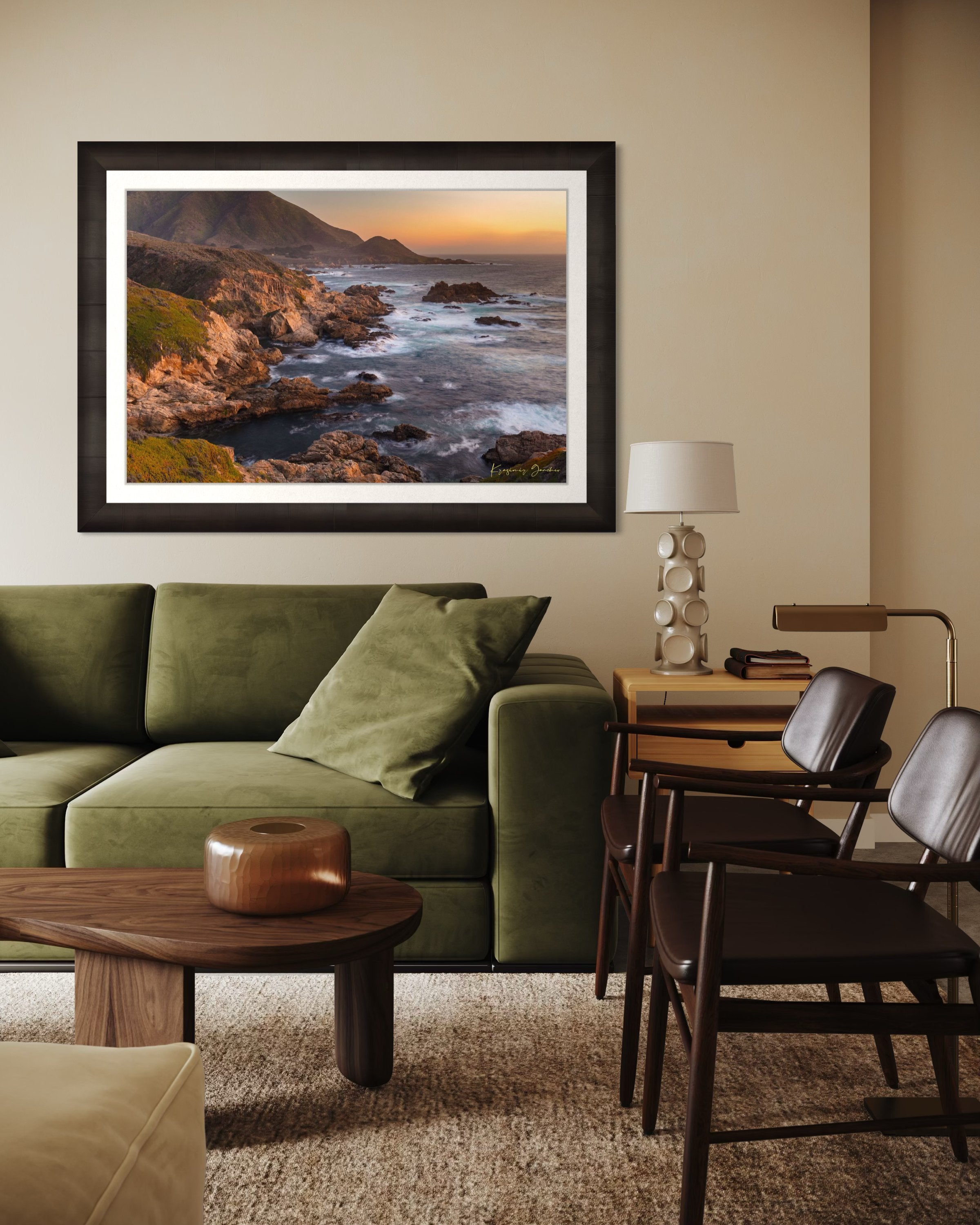 Rugged coastline of Big Sur featuring dark boulder formations, green slopes, ocean waves, and soft sunset glow across land and sea. #Finish_Roma Dark Ash Frame & Bright Liner