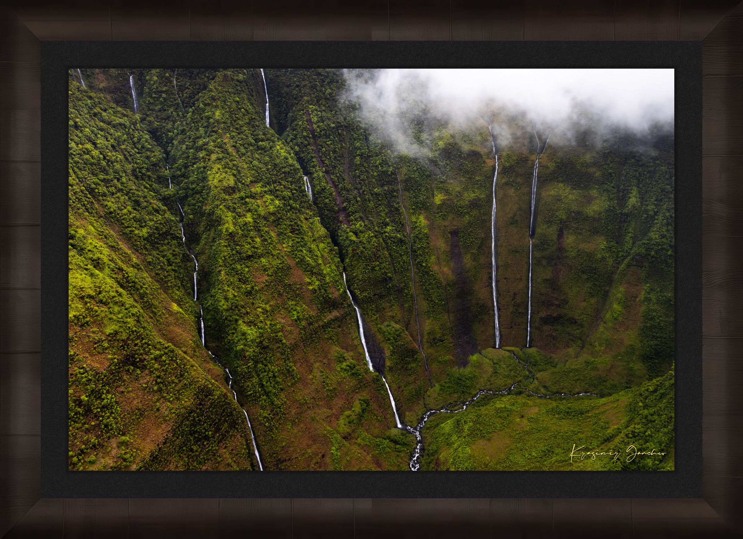 Waterfall cascading down a cliff in the Weeping Wall region, Kauai, under daytime light and cloud cover. #Finish_Roma Dark Ash Frame & Dark Liner