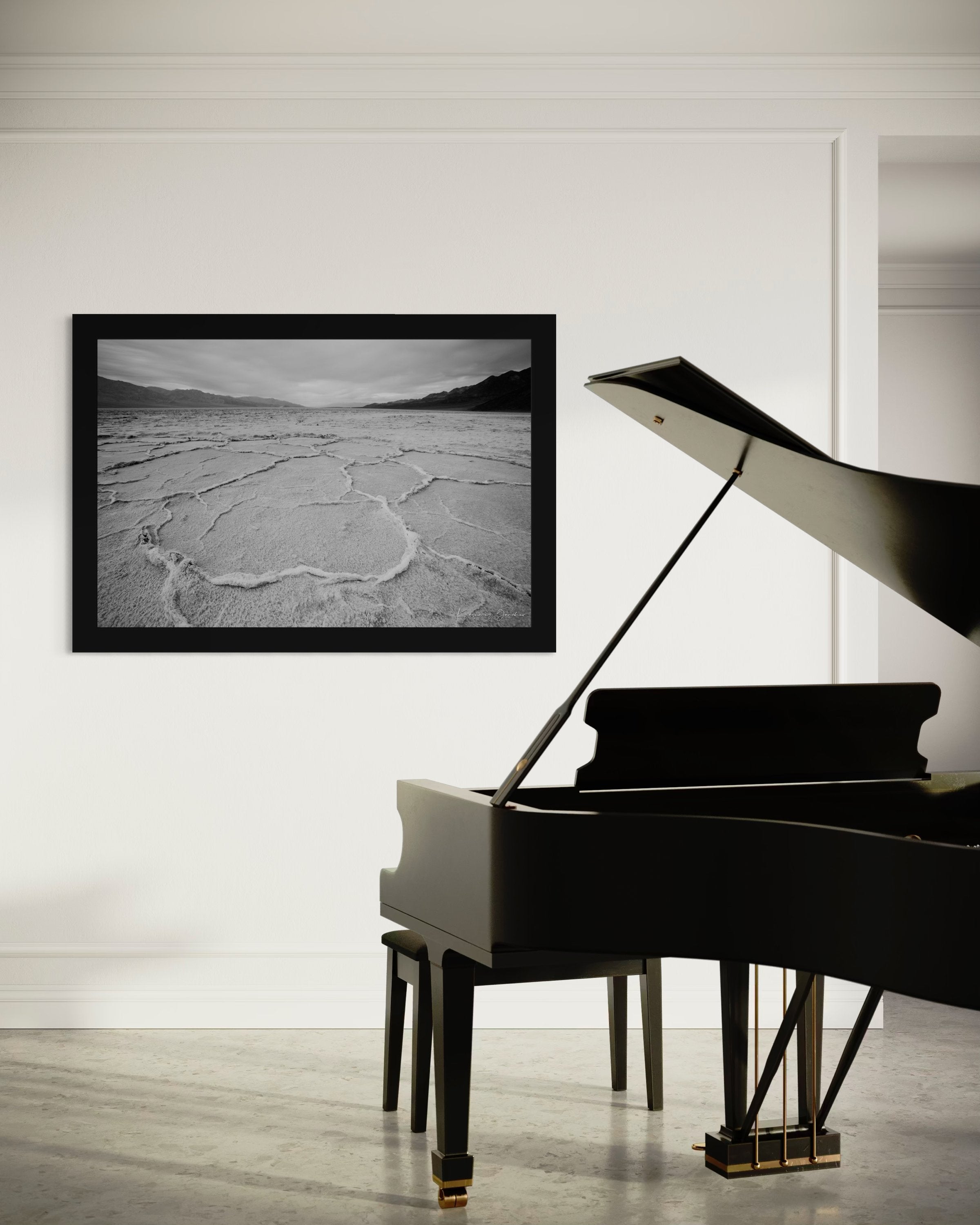 Cracked salt flat landscape in Death Valley National Park during sunset, showing textured surface under clear skies. #Finish_Roma Satin Black Frame