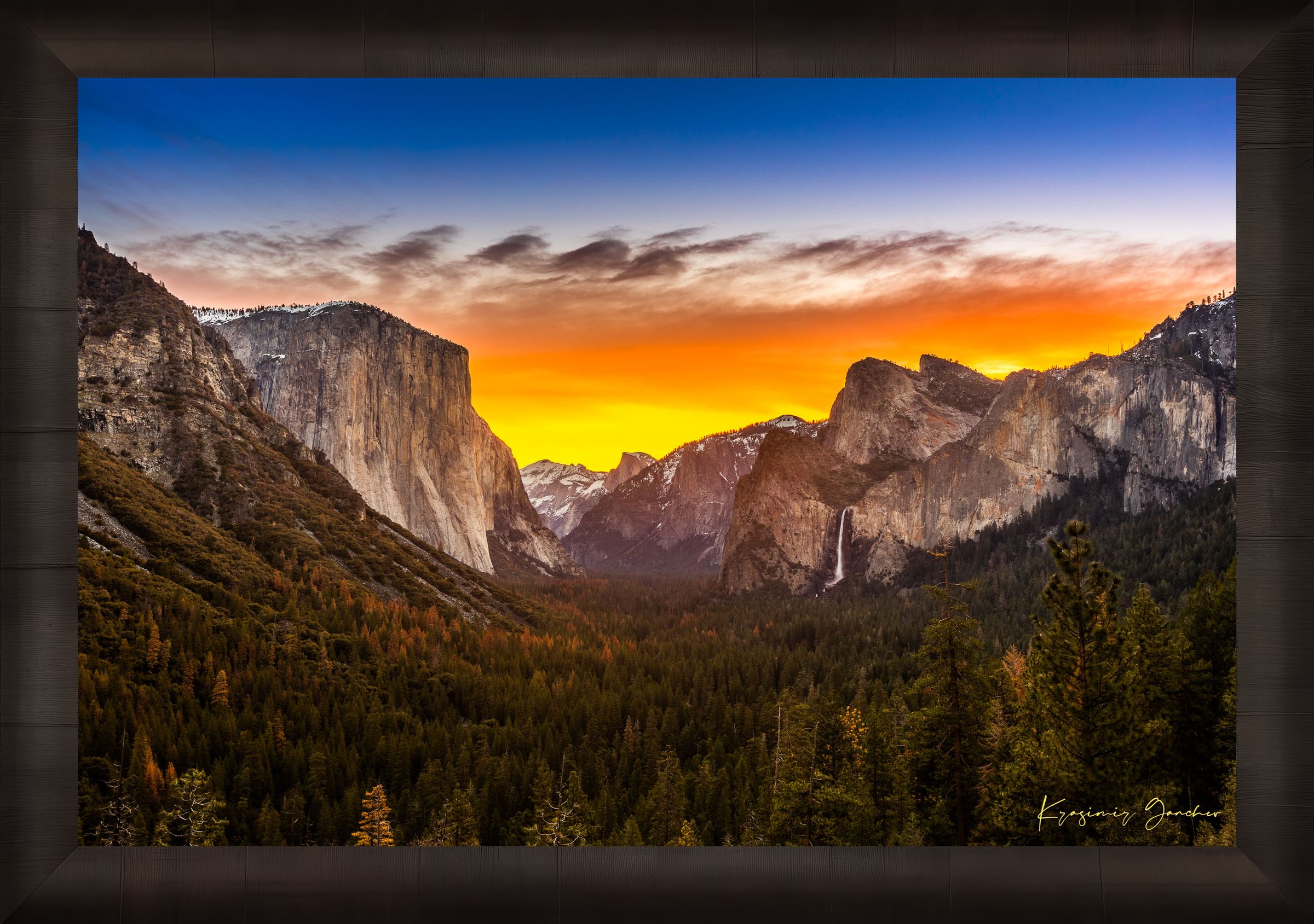 El Capitan rising above Yosemite Valley at sunrise, sunlit peaks framed by layered clouds. #Finish_Roma Dark Ash Frame