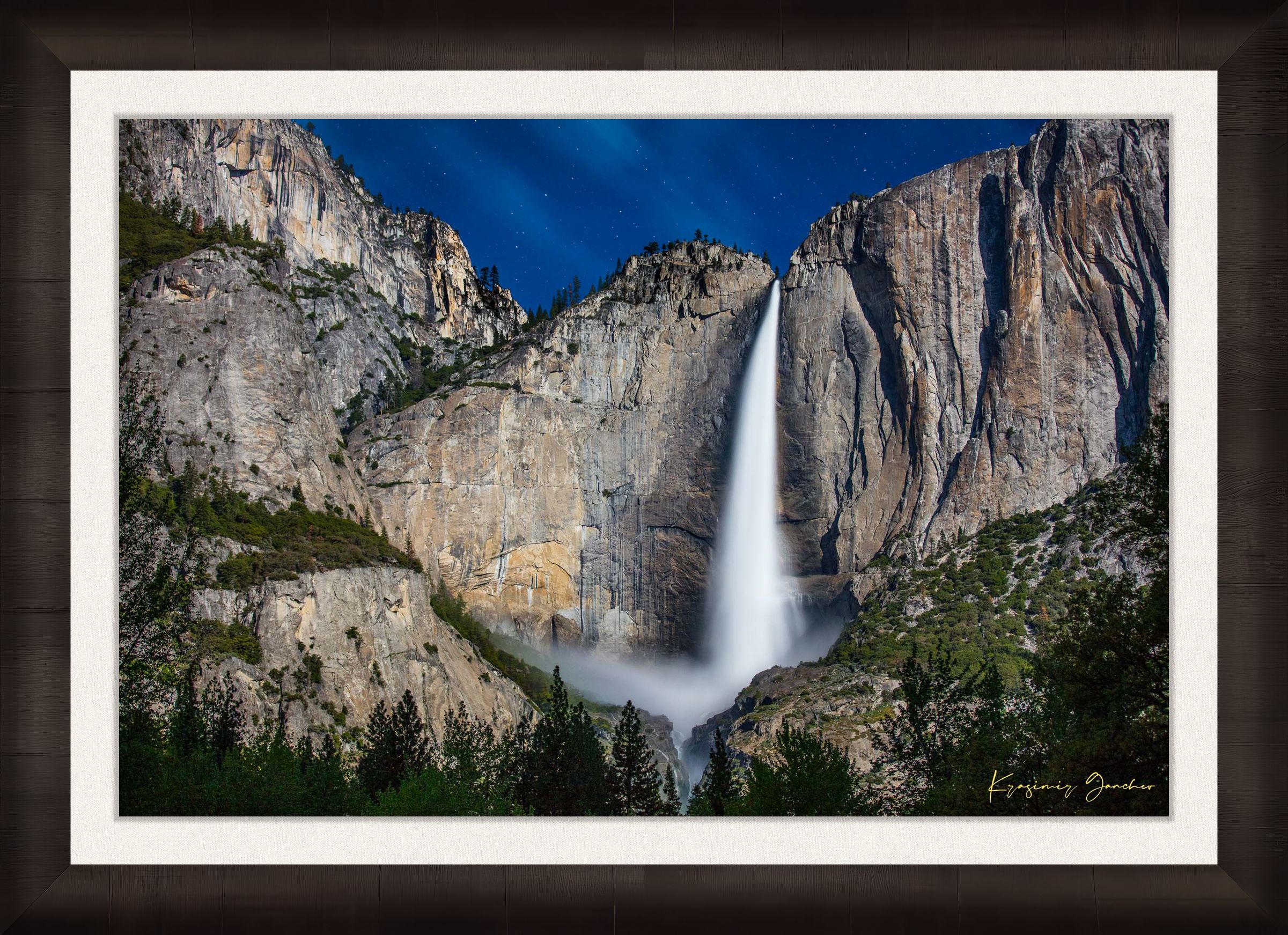 Upper Yosemite Falls illuminated by moonlight against a dark mountainous backdrop at night with cloud cover. #Finish_Roma Dark Ash Frame & Bright Liner