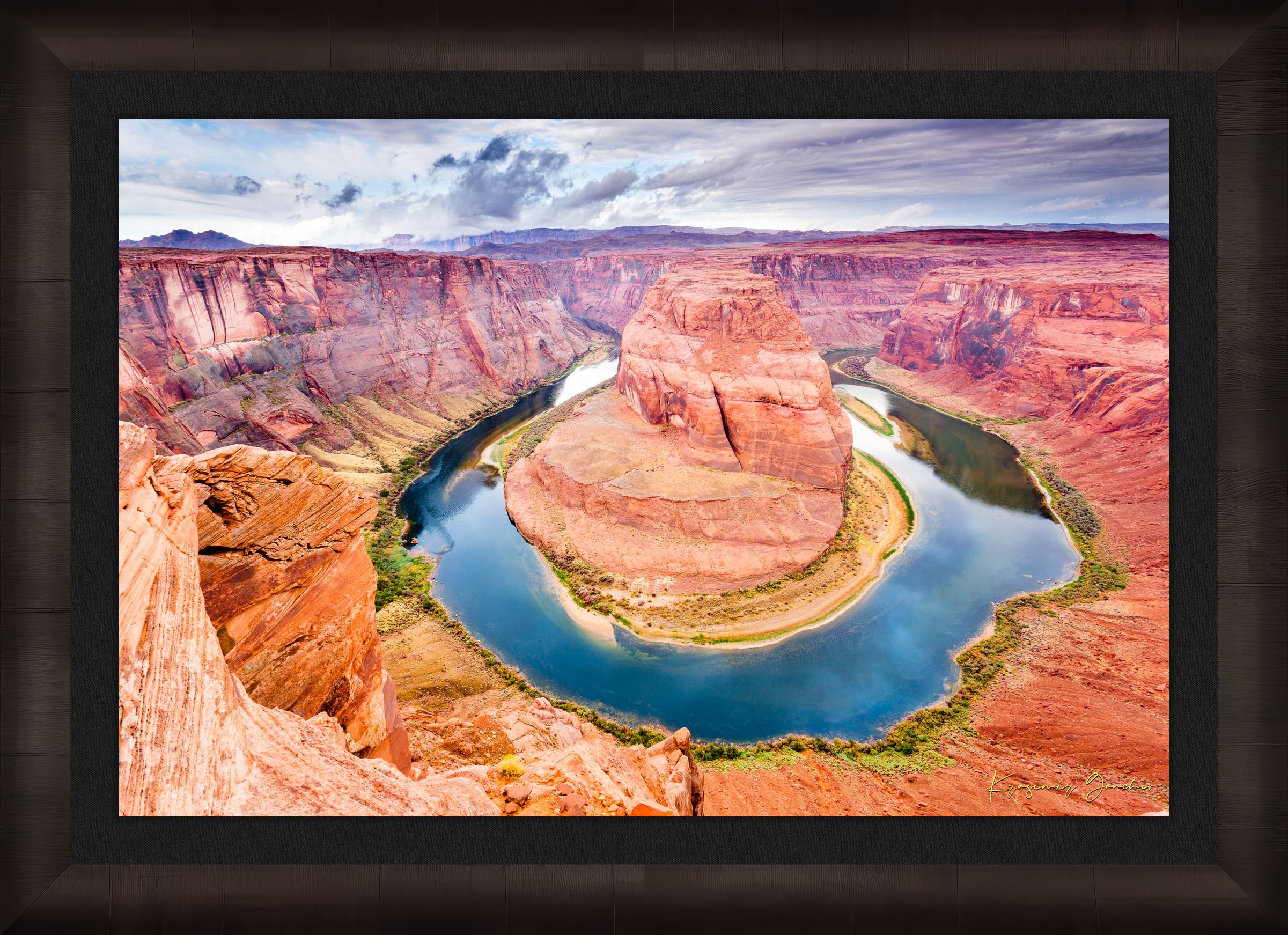Colorado River curves through Horseshoe Bend at dawn. Water reflects sunlight and surrounding red rock cliffs under cloudy skies. #Finish_Roma Dark Ash Frame & Dark Liner