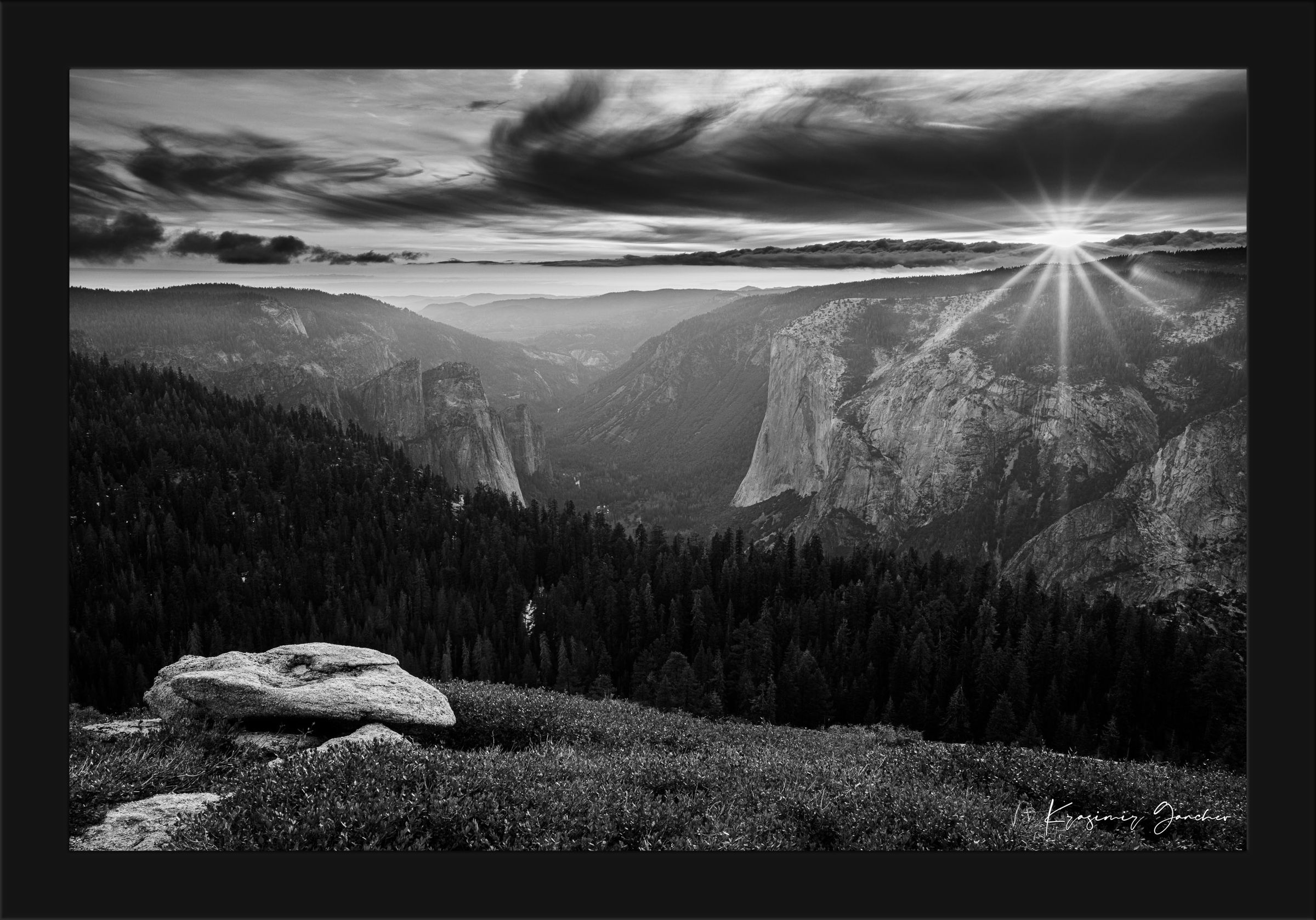El Capitan at sunset, radiant starburst above horizon casting long shadows on valley terrain. #Finish_Roma Satin Black Frame