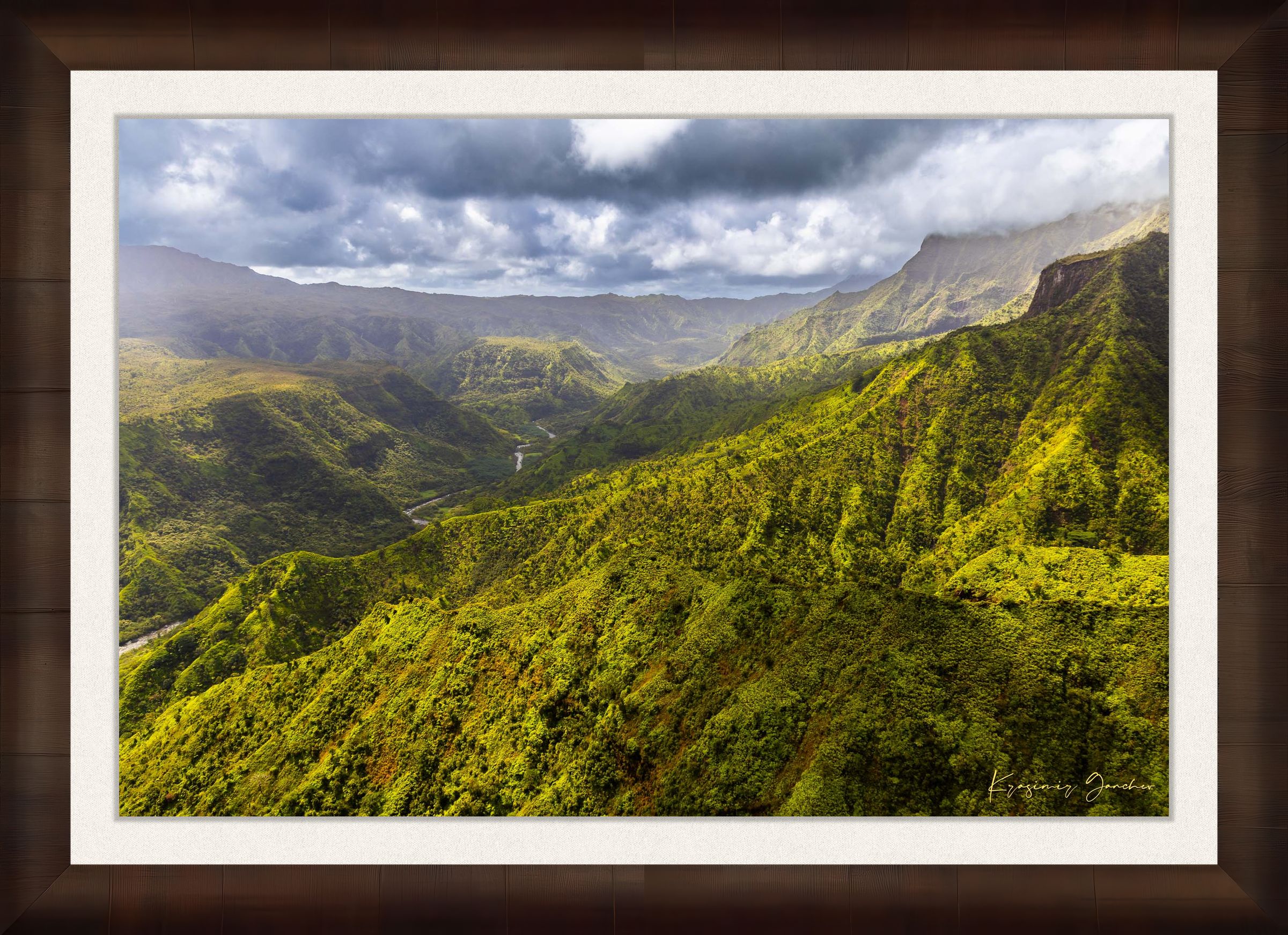 Expansive aerial view of a mountainous valley in Kauai illuminated by daylight, covered in low-lying cloud. #Finish_Roma Cigar Leaf Frame & Bright Liner