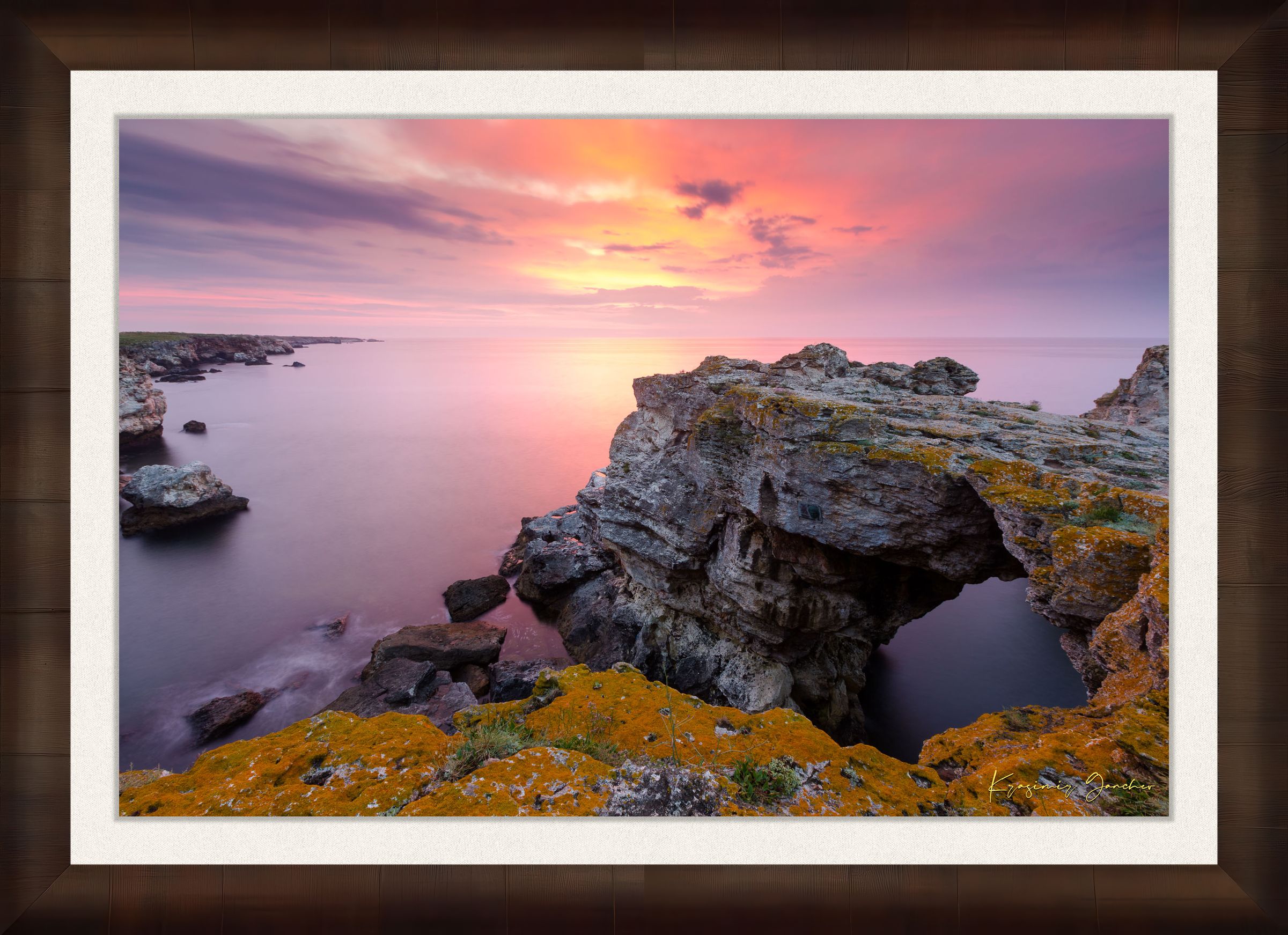 The natural arch formation of the Tyulenovo Arch at dawn in Tyulenovo, Bulgaria, lit by sunrise and surrounded by vegetation. #Finish_Roma Cigar Leaf Frame & Bright Liner