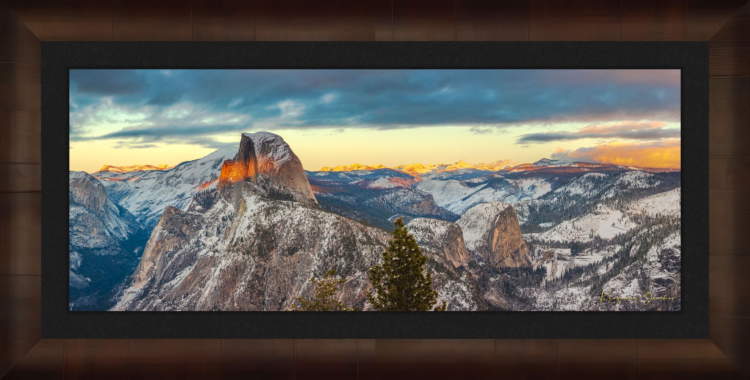 Sunset view of Half Dome monolith with dynamic shadows and sunlight over snow-dusted peaks and clouds in Yosemite National Park. #Finish_Roma Cigar Leaf Frame & Dark Liner