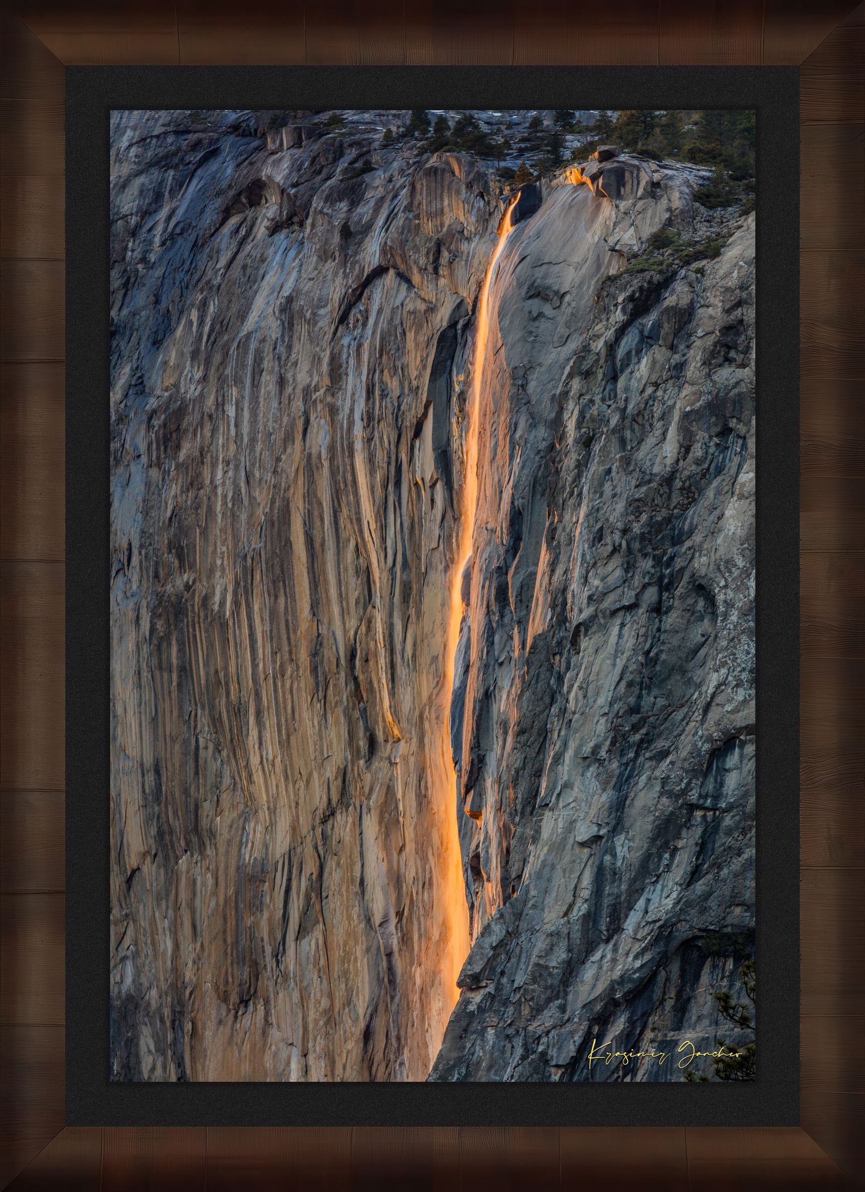 Detailed view of the firefall effect on El Capitan monolith with glowing sunlight refracting through mist from Horsetail Fall in Yosemite. #Finish_Roma Cigar Leaf Frame & Dark Liner