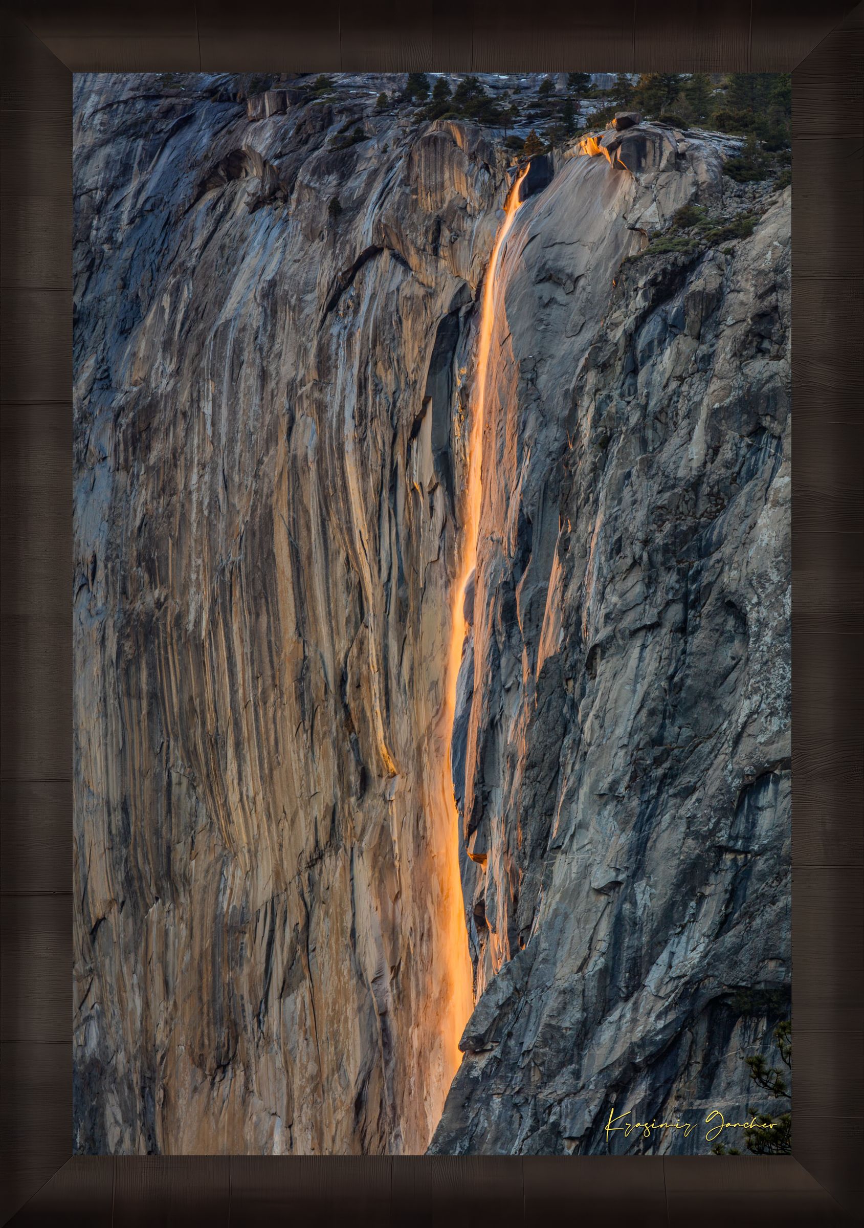 Detailed view of the firefall effect on El Capitan monolith with glowing sunlight refracting through mist from Horsetail Fall in Yosemite. #Finish_Roma Dark Ash Frame