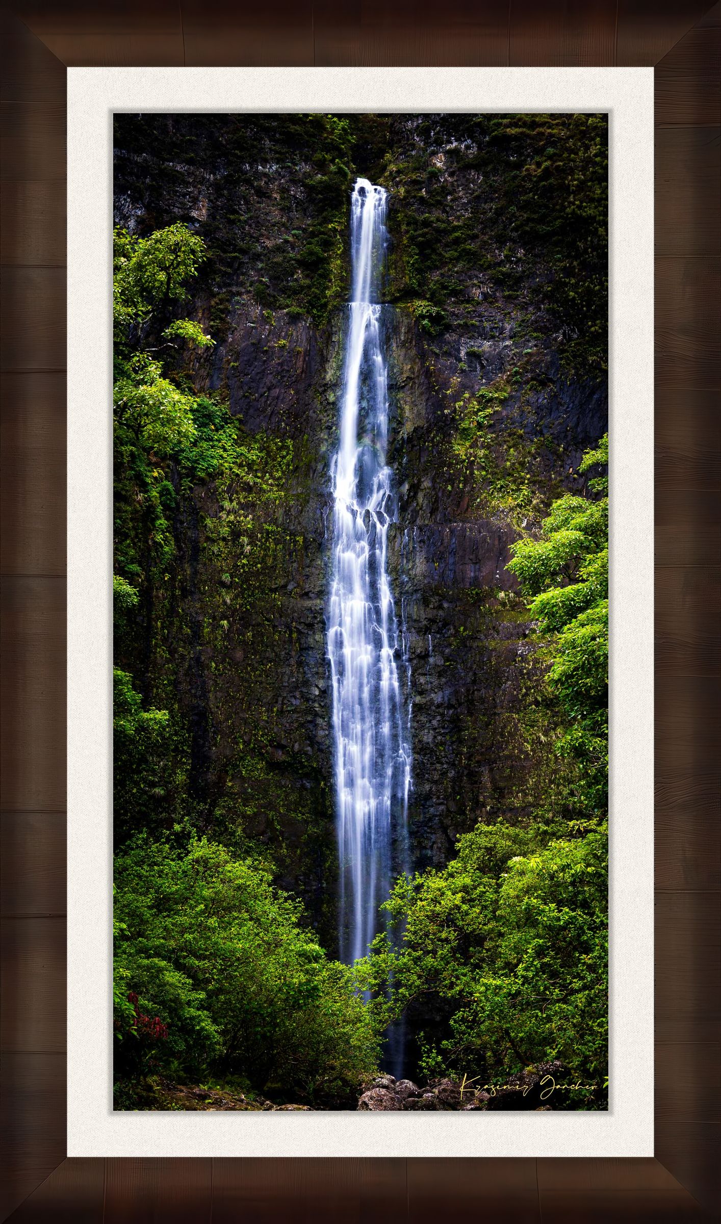Waterfall cascading down cliff face within Na Pali Coast region of Kauai under daylight conditions. #Finish_Roma Cigar Leaf Frame & Bright Liner