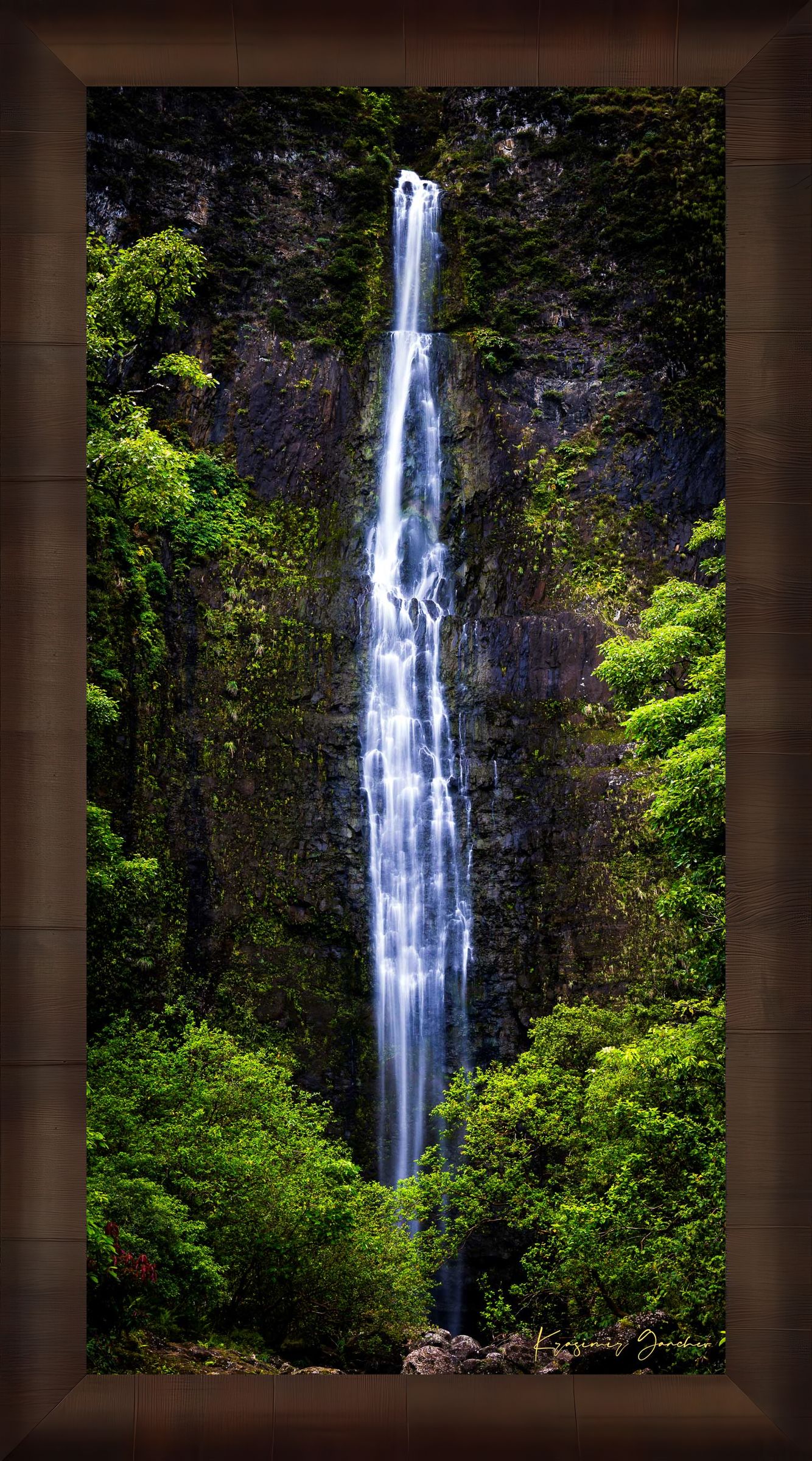Waterfall cascading down cliff face within Na Pali Coast region of Kauai under daylight conditions. #Finish_Roma Cigar Leaf Frame