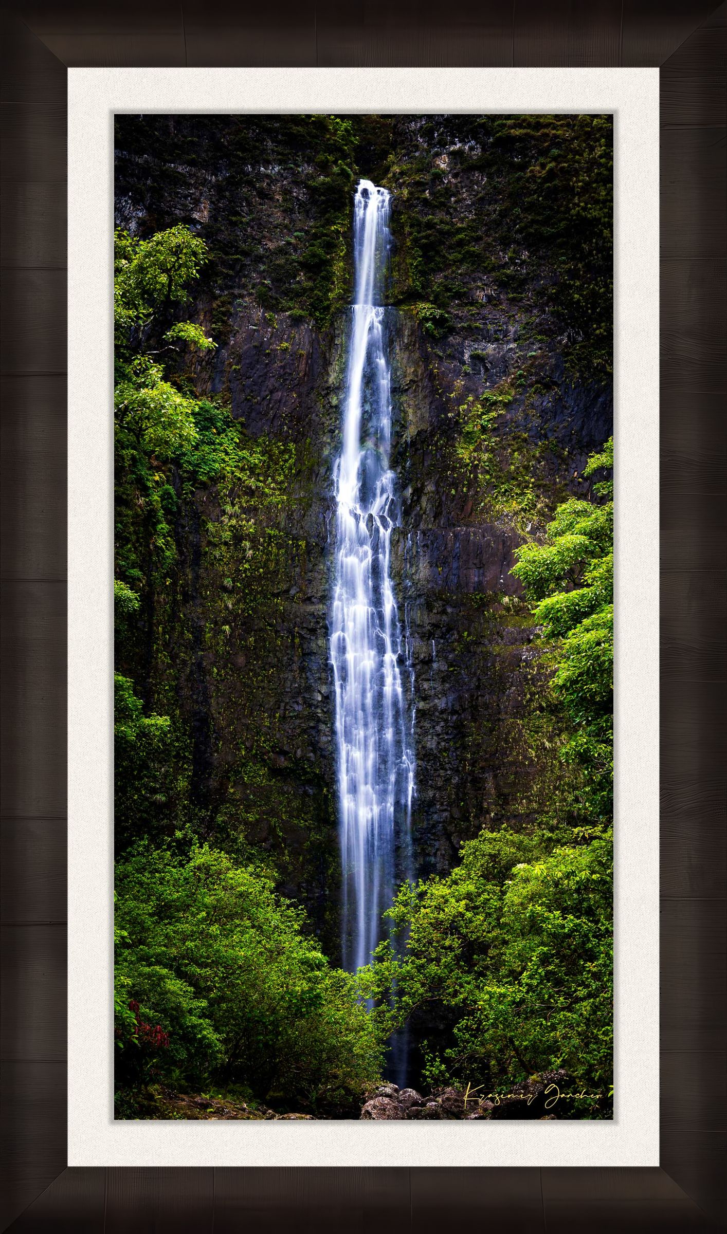 Waterfall cascading down cliff face within Na Pali Coast region of Kauai under daylight conditions. #Finish_Roma Dark Ash Frame & Bright Liner