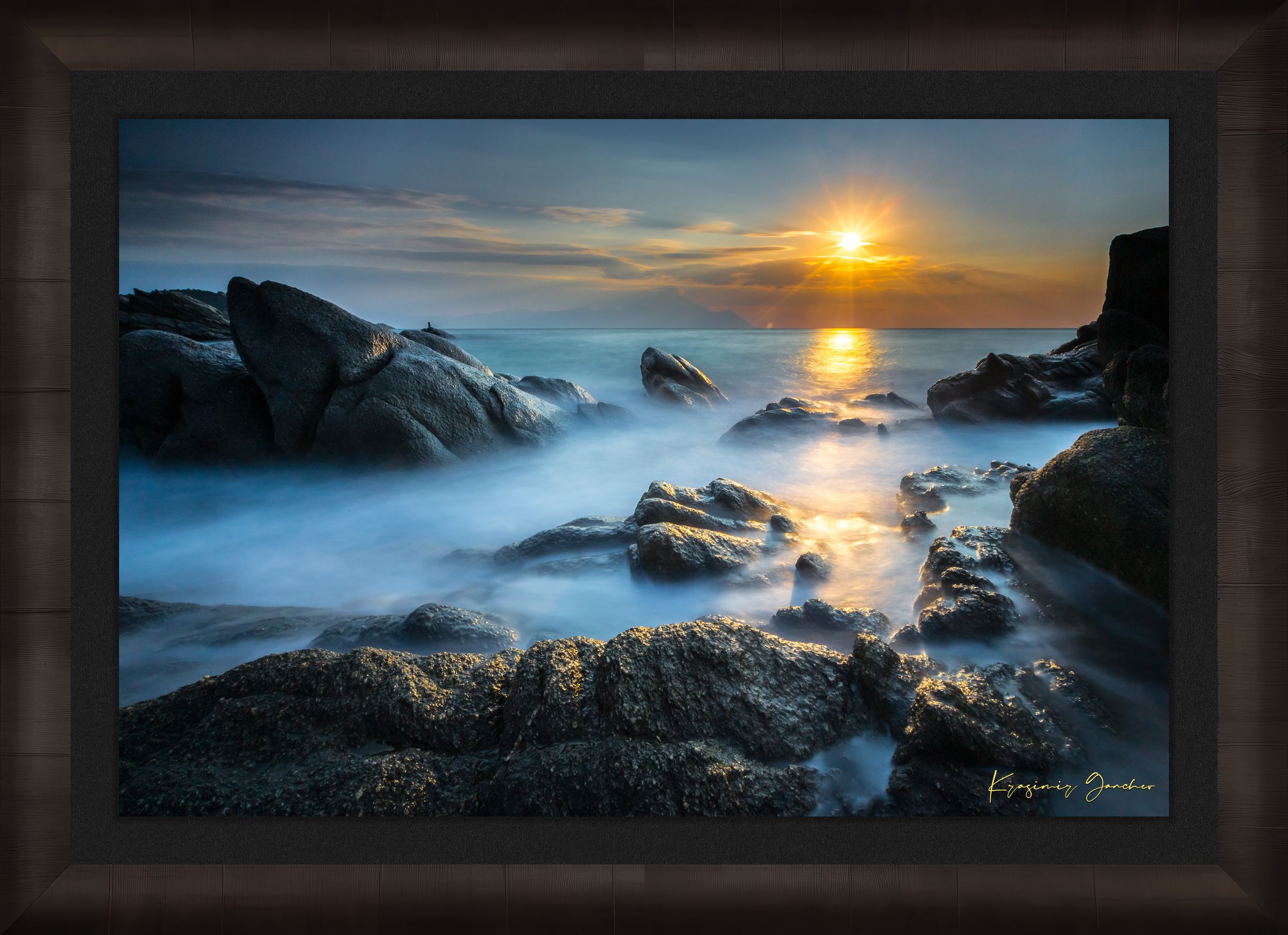 Coastal rocks with a sea stack at sunrise, soft light on the moving sea surface. Taken in Sarti, Greece. #Finish_Roma Dark Ash Frame & Dark Liner