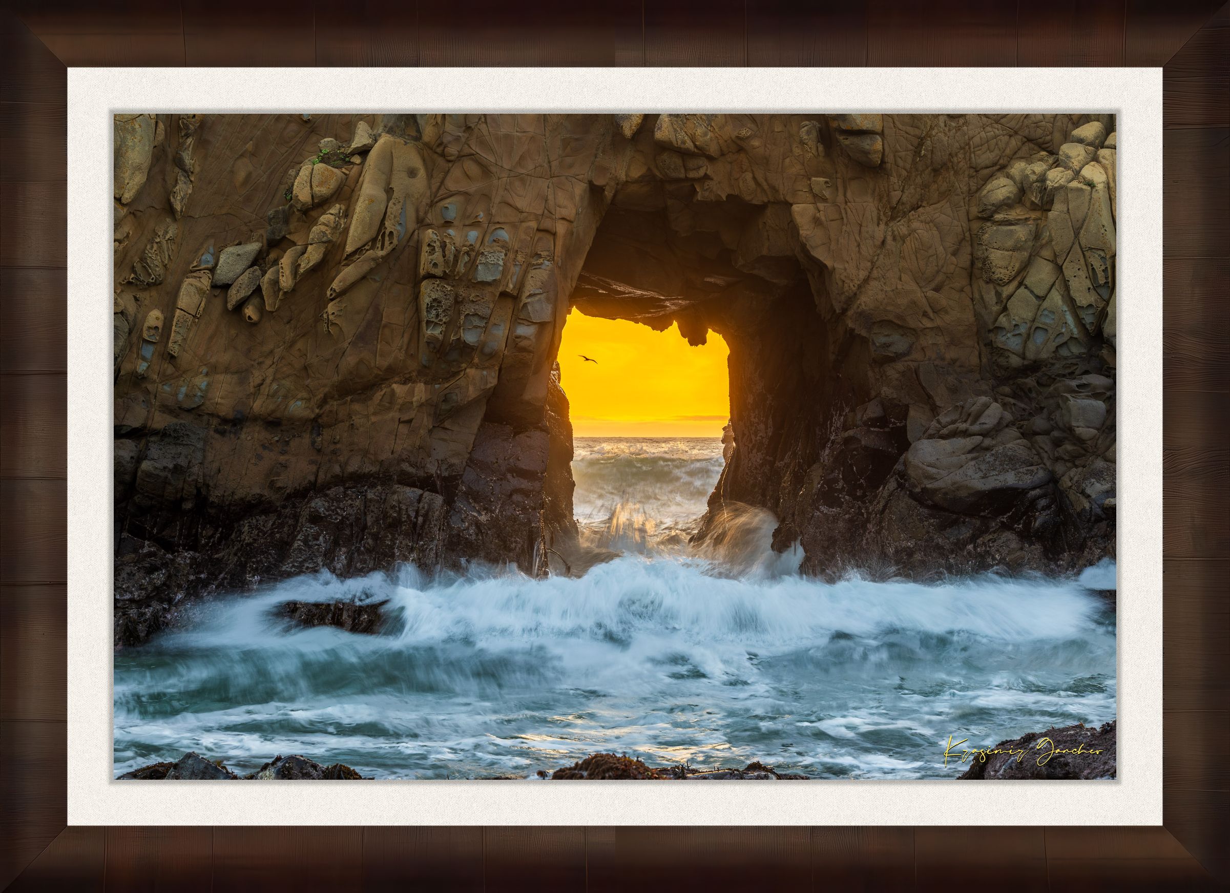 Natural rock arch on the Pacific coast of Big Sur framed by a vivid sunset, wave motion softened by long exposure. #Finish_Roma Cigar Leaf Frame & Bright Liner