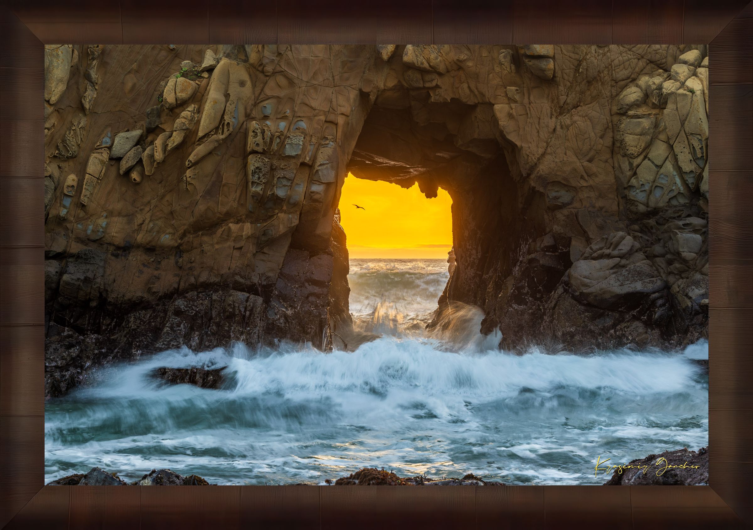 Natural rock arch on the Pacific coast of Big Sur framed by a vivid sunset, wave motion softened by long exposure. #Finish_Roma Cigar Leaf Frame