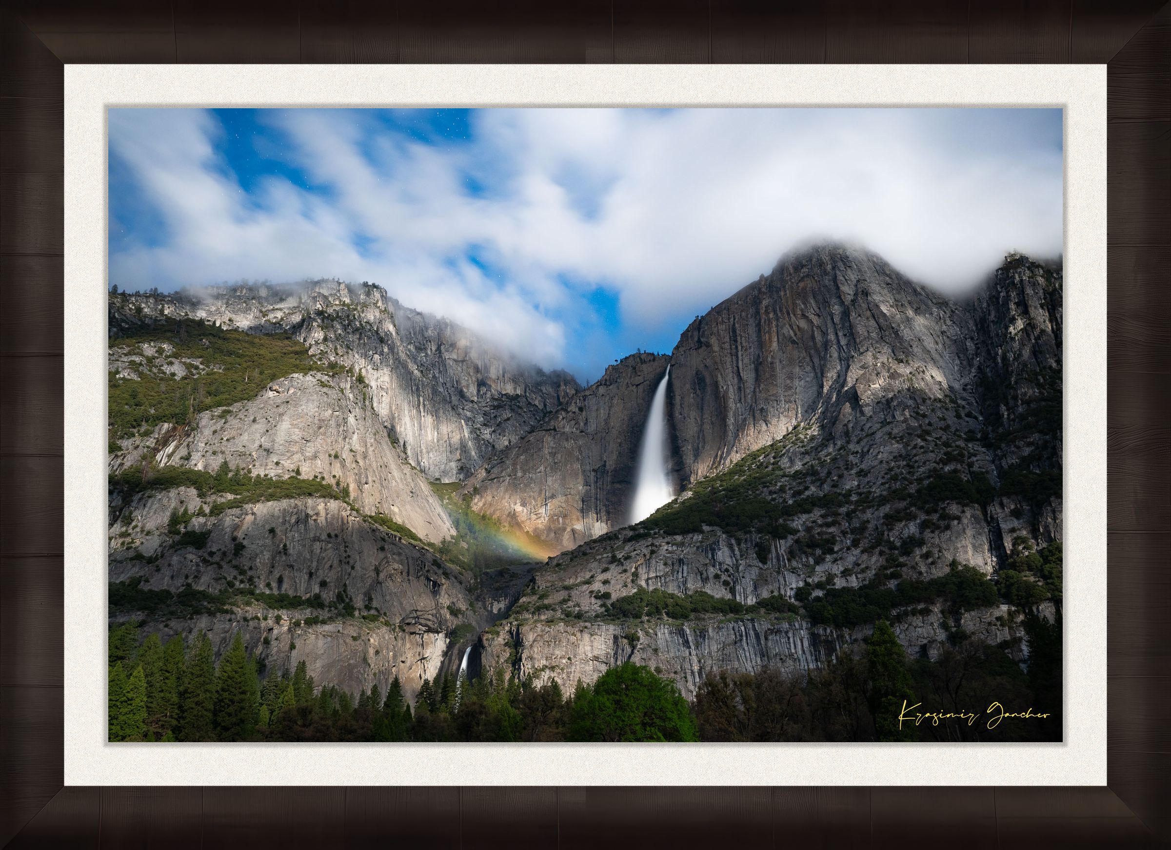 Yosemite Falls at night under starlight, illuminated by a faint silvery moonbow arching above the cascade within a cloudy mountain valley. #Finish_Roma Dark Ash Frame & Bright Liner