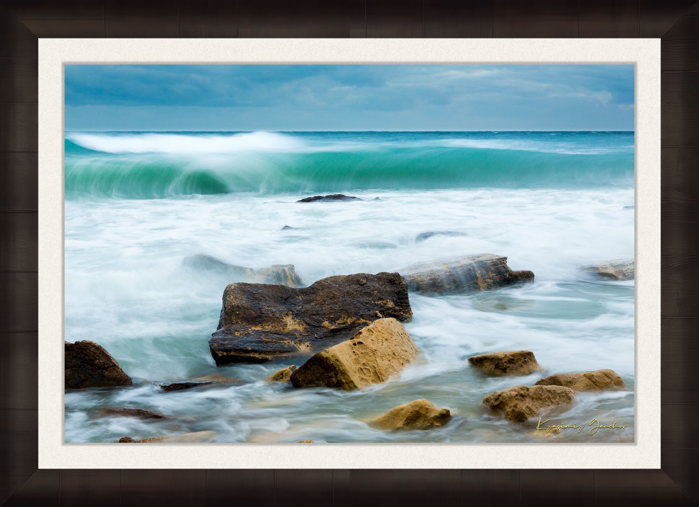 Waves from the sea crash against coastal boulder formations near Fichoza, Bulgaria during daylight with cloudy weather. #Finish_Roma Dark Ash Frame & Bright Liner