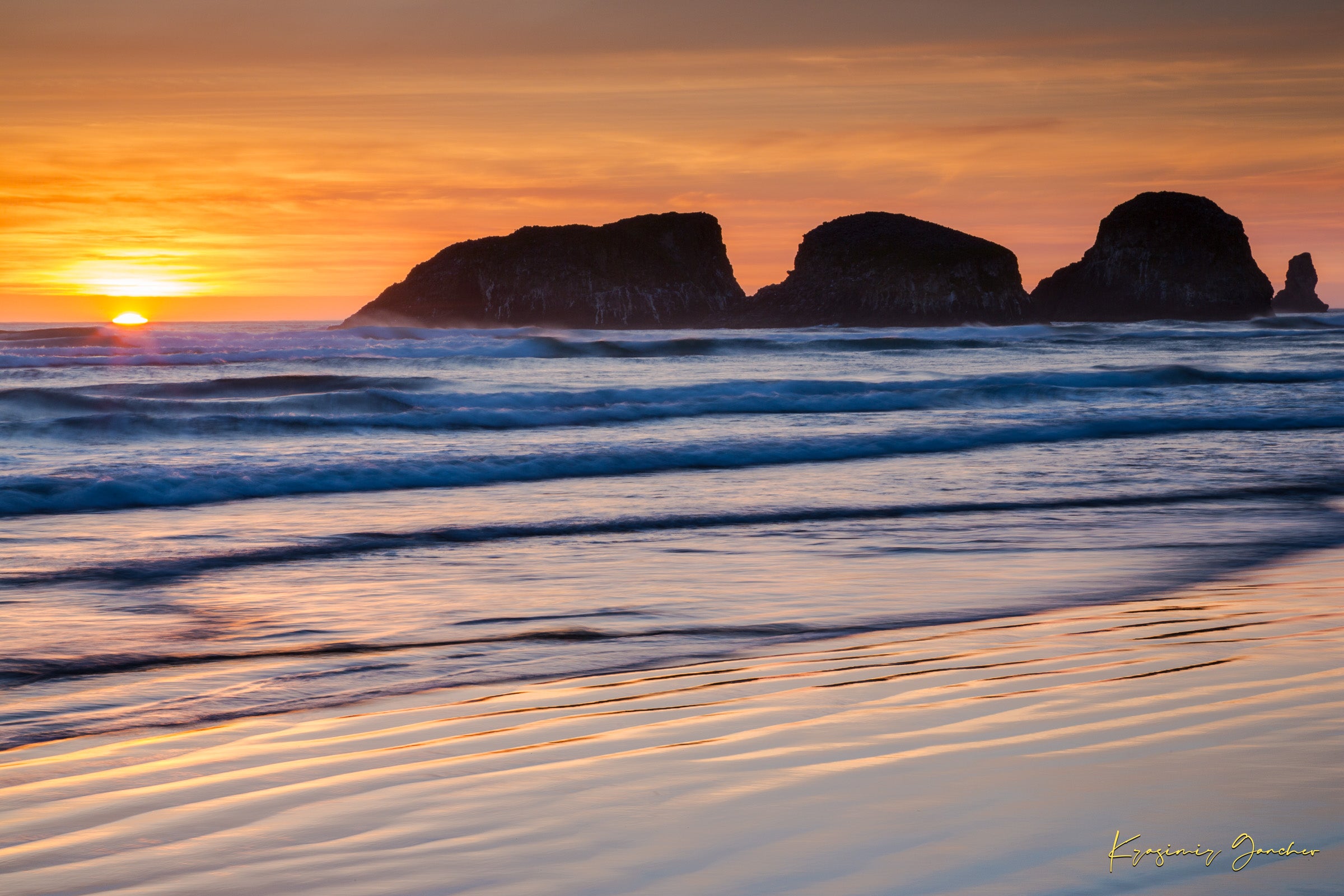 Bird Rock at Cannon Beach, Oregon, during sunset with reflections in the wet sand and ocean under cloudy skies. #Finish_Acrylic Recess