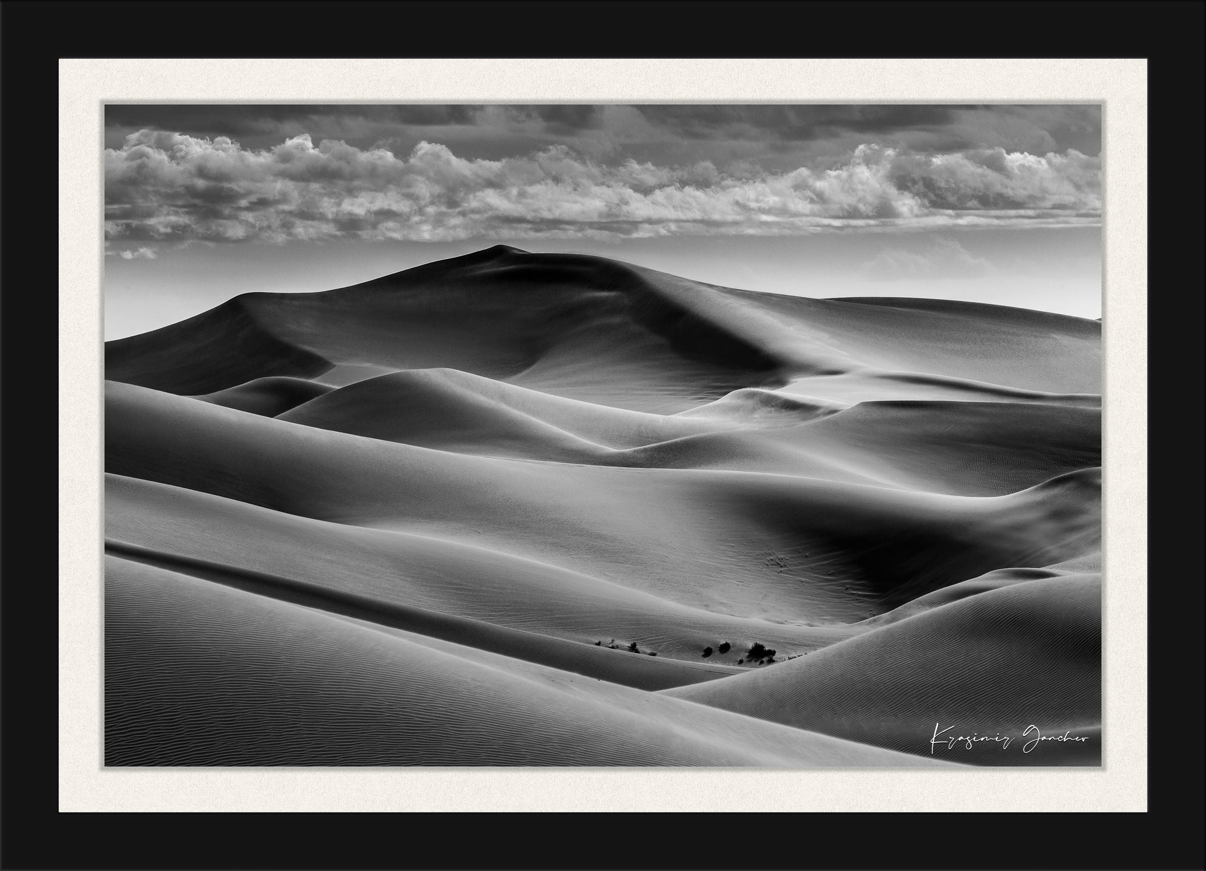 Black-and-white composition capturing the undulating dune patterns at Brawley, California with strong light and shadow contrast. #Finish_Roma Satin Black Frame & Bright Liner
