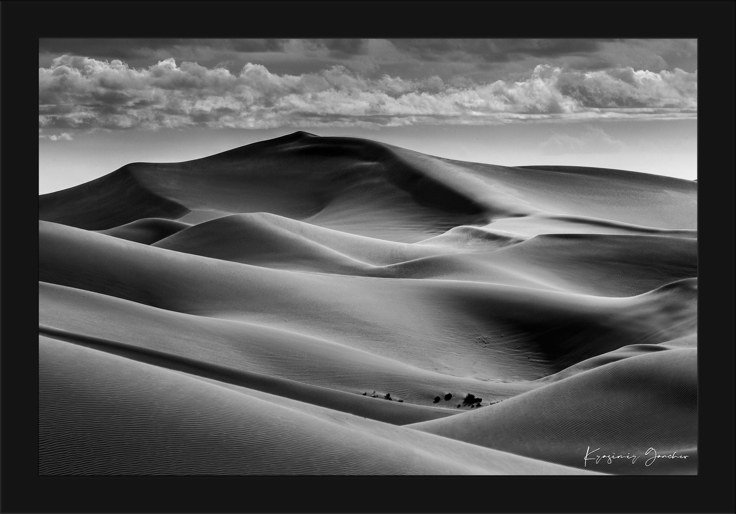 Black-and-white composition capturing the undulating dune patterns at Brawley, California with strong light and shadow contrast. #Finish_Roma Satin Black Frame