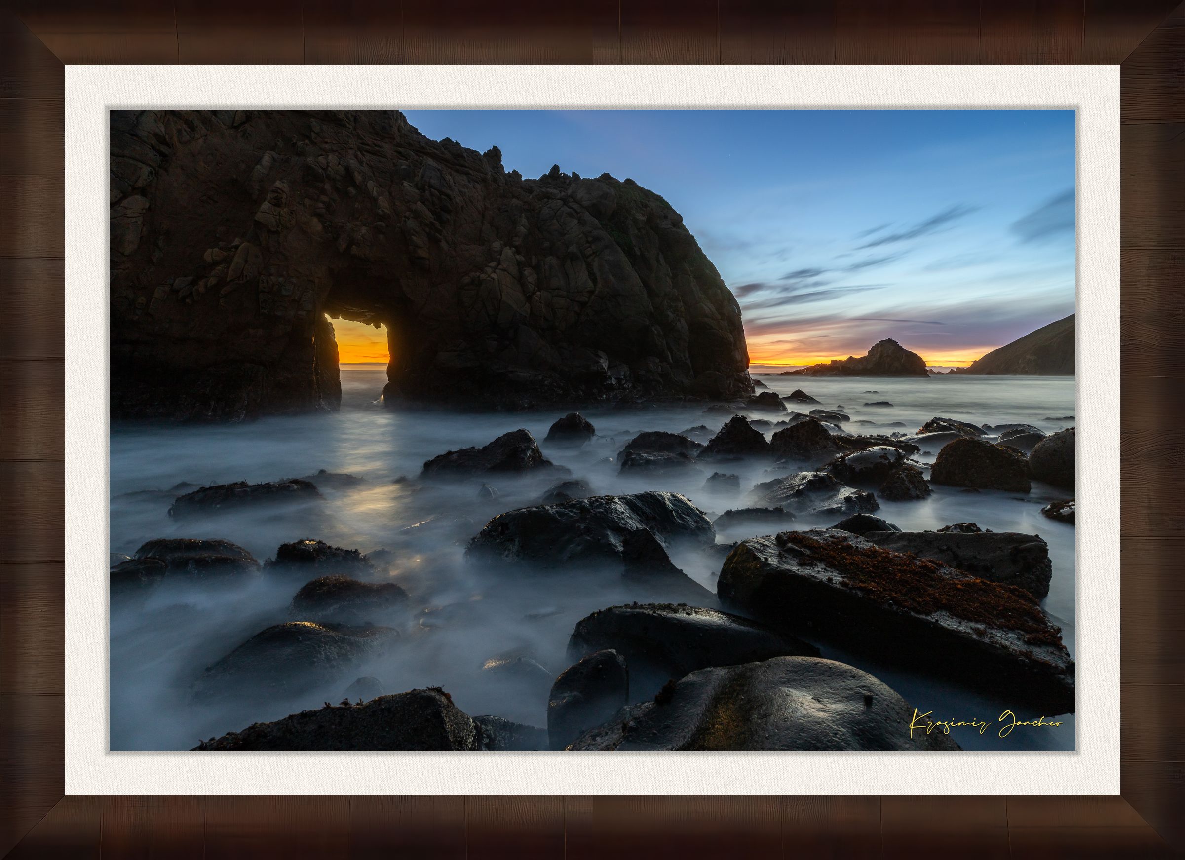 Natural arch structure with boulders and sea stack near Big Sur, California, lit by intense sunset rays through a stone opening. #Finish_Roma Cigar Leaf Frame & Bright Liner