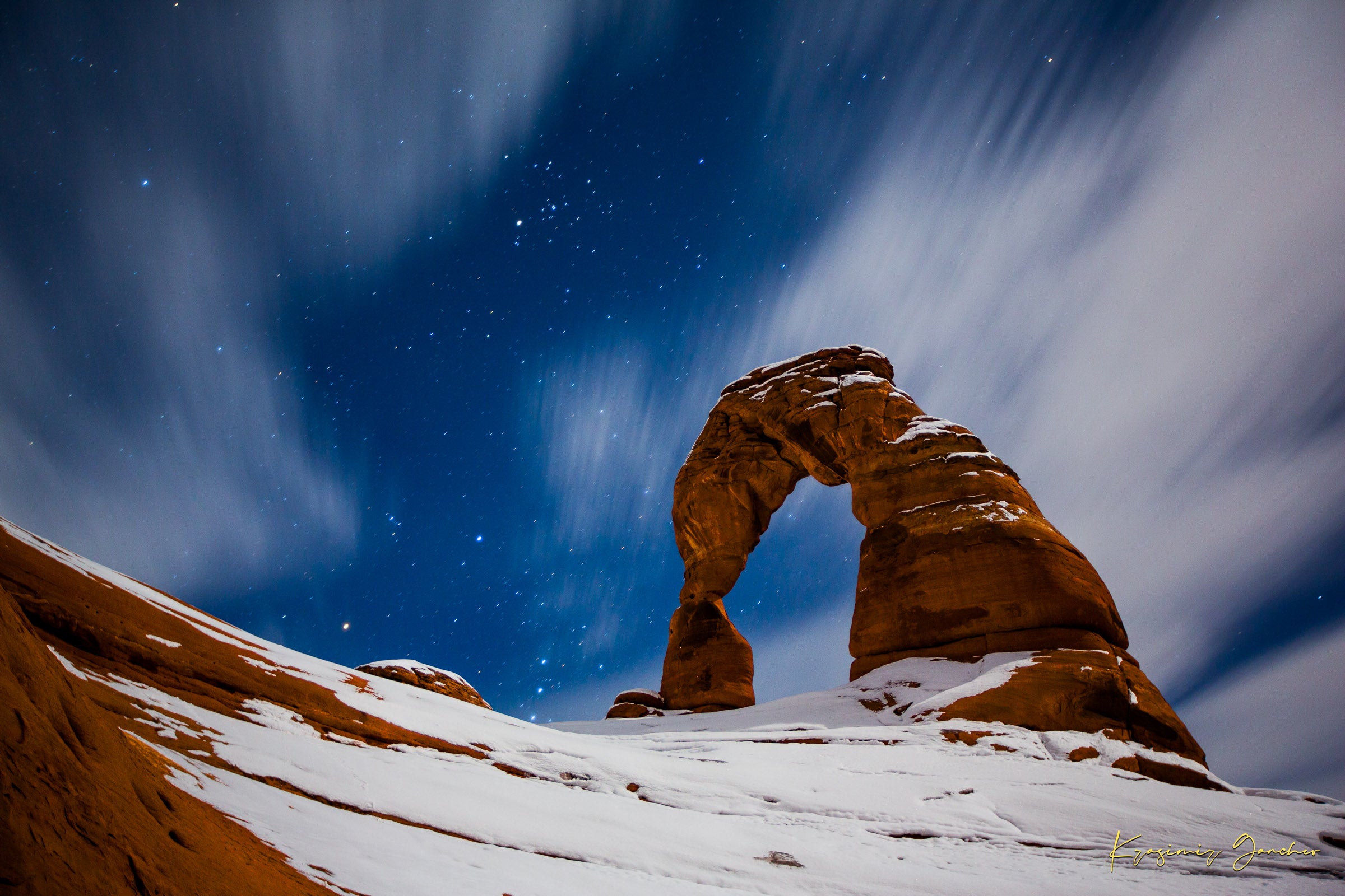 Iconic arch formation in Arches National Park captured during nighttime with starlight and light snow enhancing the serene desert scene. #Finish_Acrylic Recess