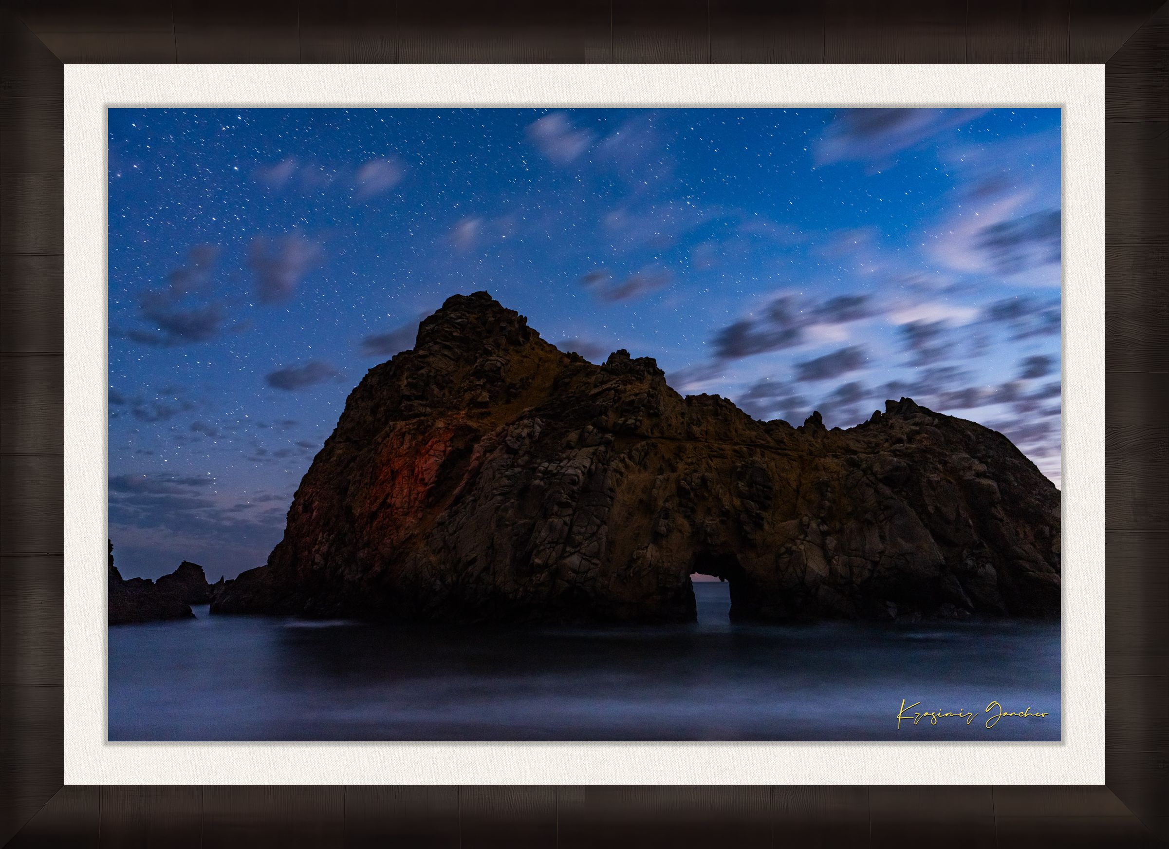 Keyhole Arch silhouette against a starry sky over the ocean at Pfeiffer Beach in Big Sur, California. #Finish_Roma Dark Ash Frame & Bright Liner
