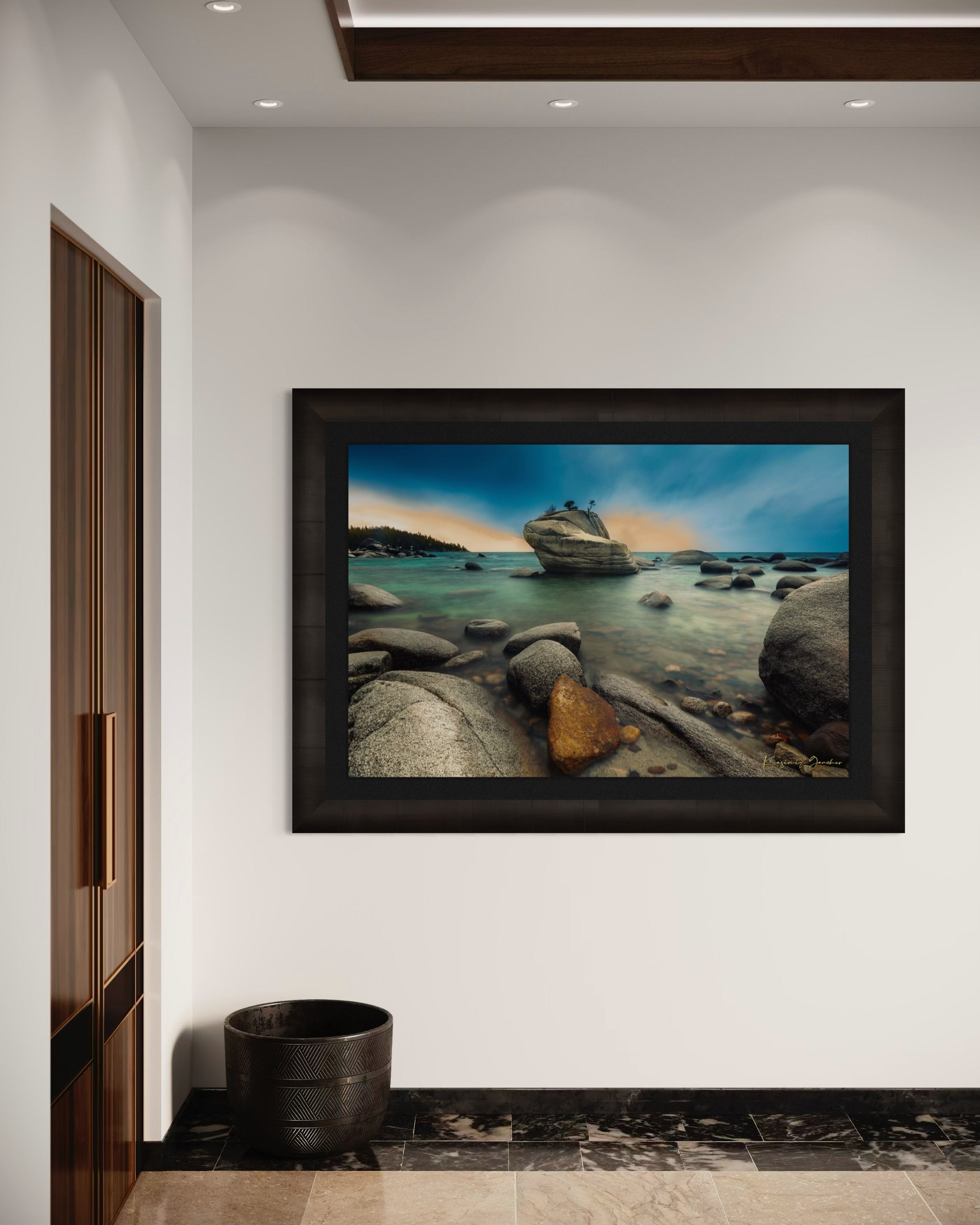 Bonsai Rock formation beside a calm lake in Lake Tahoe during sunset with gentle ripples and clouds. #Finish_Roma Dark Ash Frame & Dark Liner