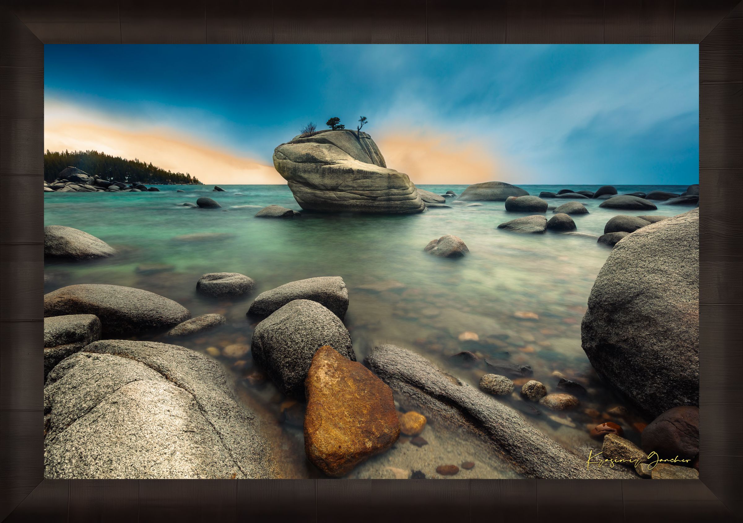 Bonsai Rock formation beside a calm lake in Lake Tahoe during sunset with gentle ripples and clouds. #Finish_Roma Dark Ash Frame