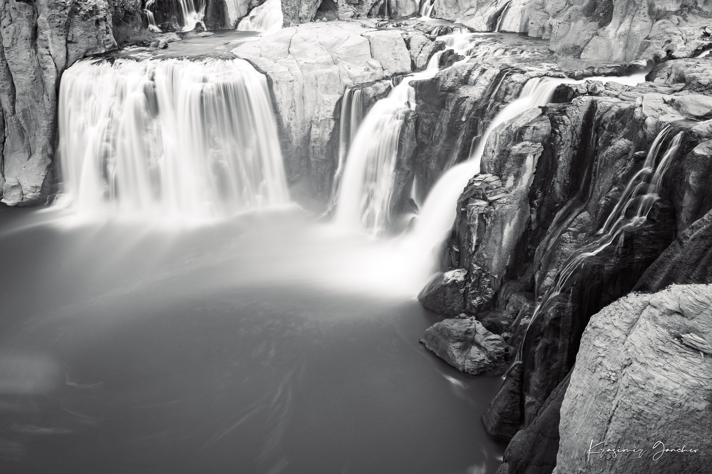 Black and white photograph of a powerful Shoshone Falls waterfall cascading into dark recesses with blurred water motion. #Finish_Acrylic Recess