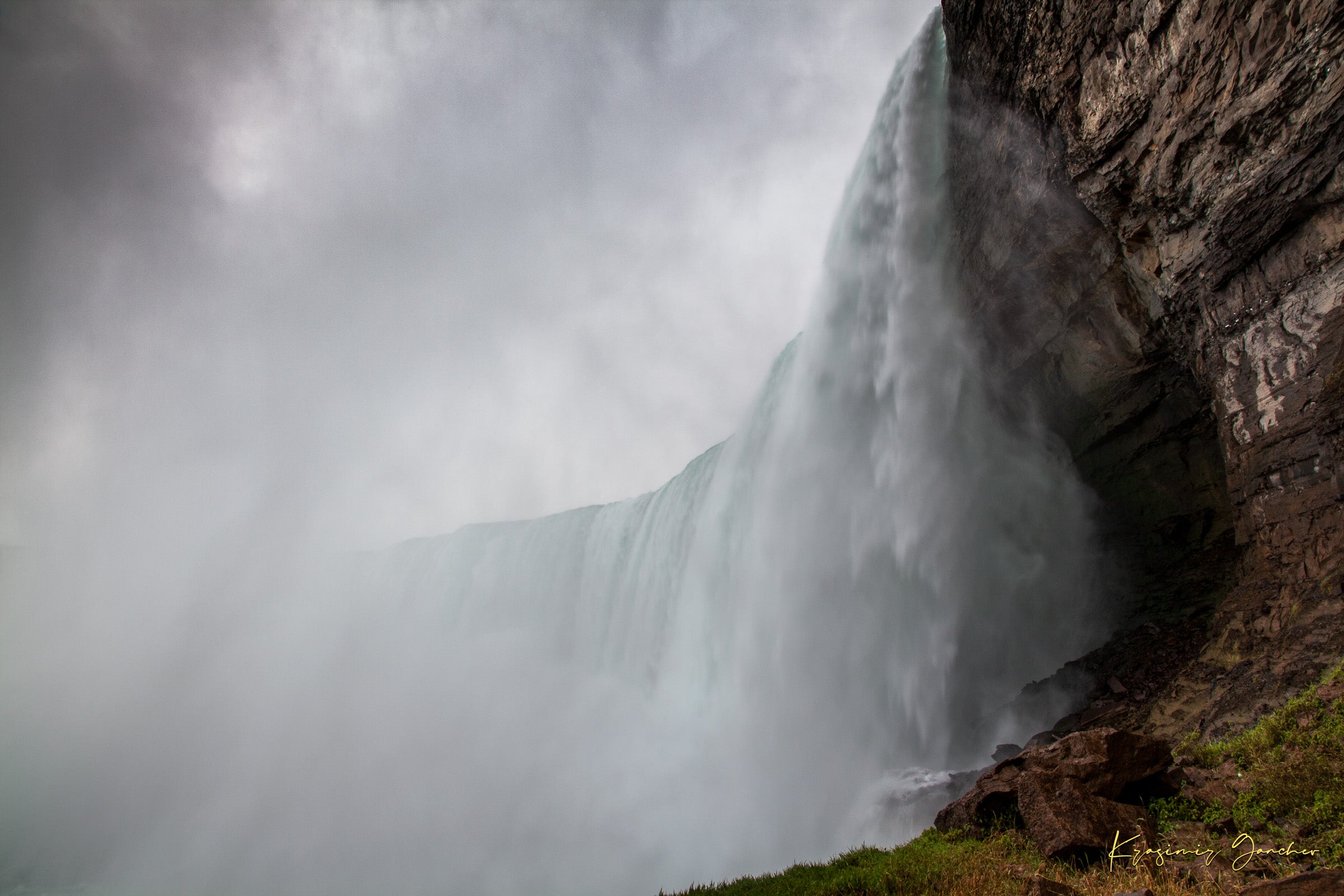 Waterfall descending from cliff edge at Niagara Falls, surrounded by mist and storm clouds. #Finish_Acrylic Recess