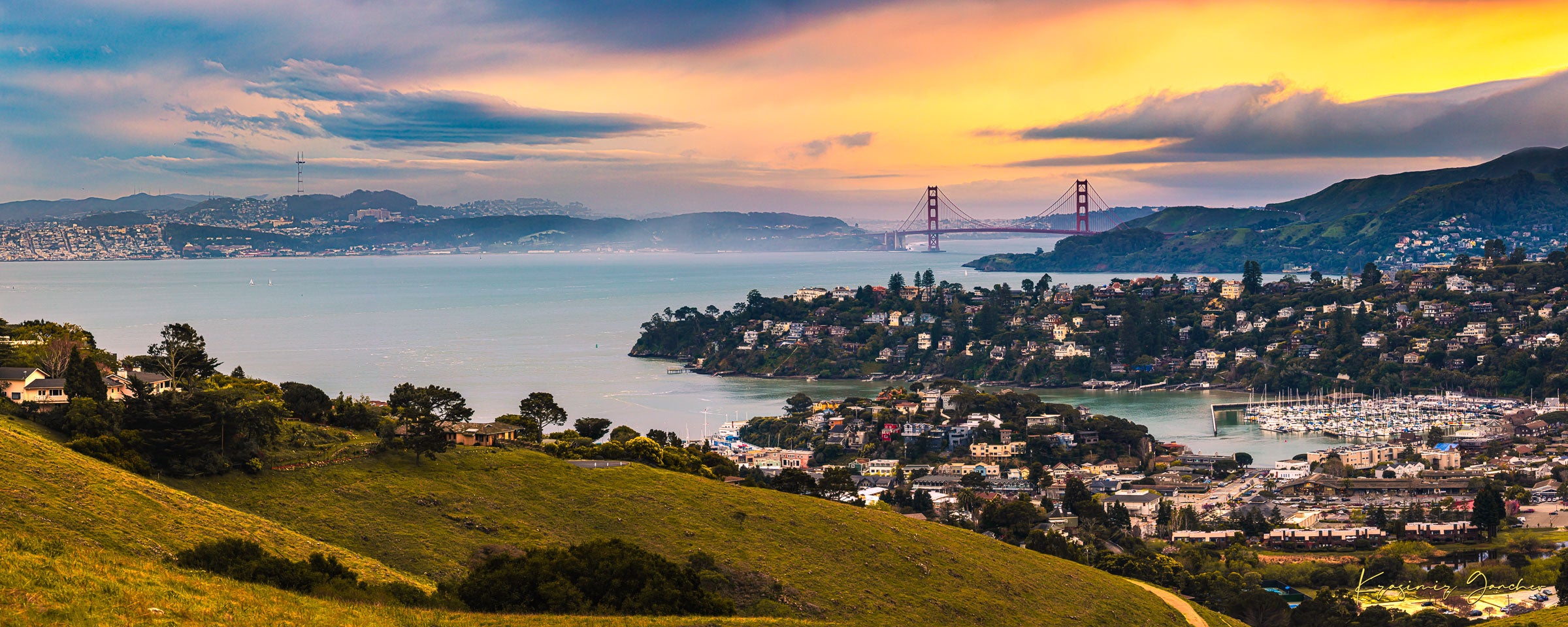 Golden Gate Bridge illuminated at sunset above the San Francisco Bay, showing light trails and cloudy skies with Tiburon in foreground. #Finish_Acrylic Recess