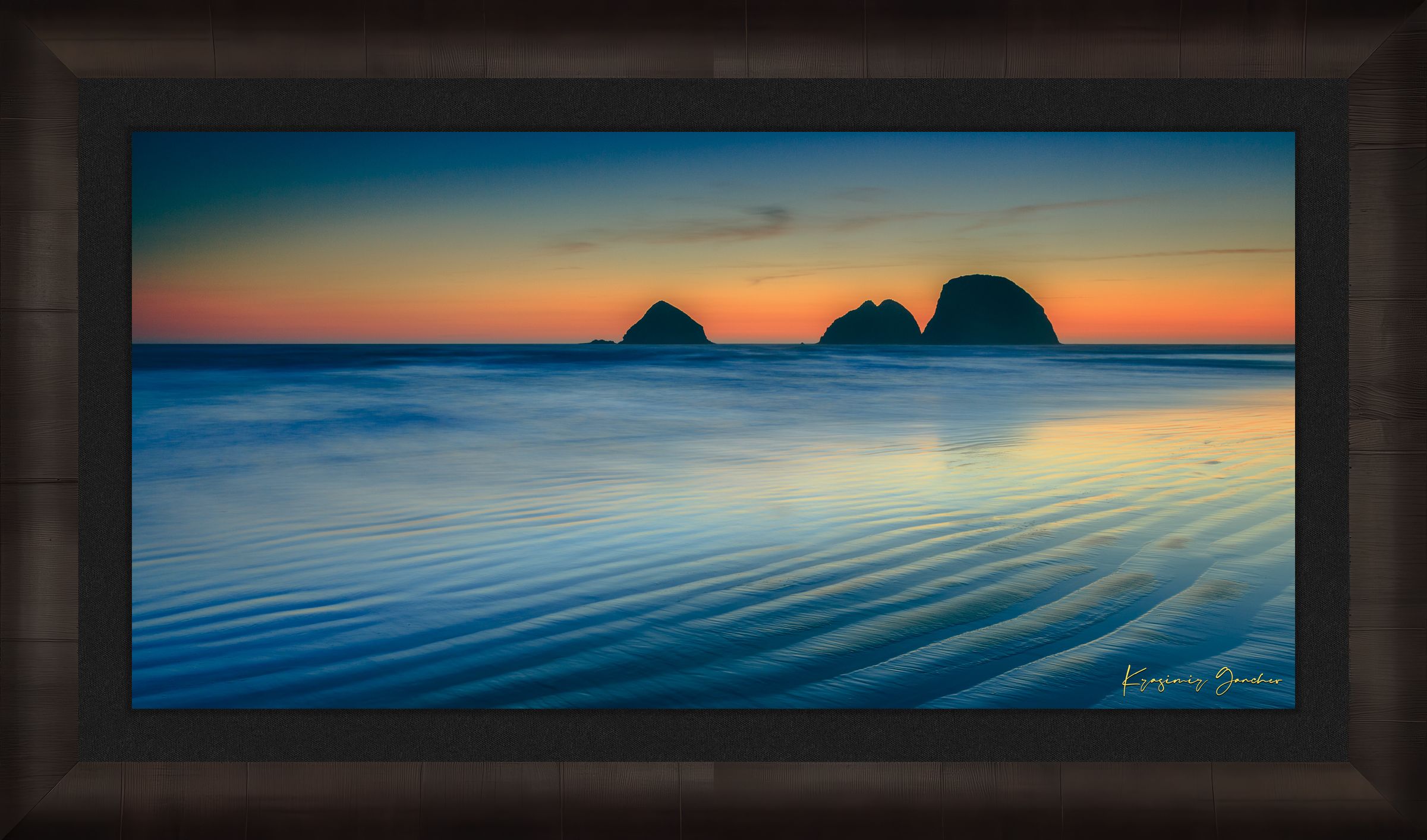 Silhouette of Bird Rock formations against a hazy twilight sky along Canon Beach oceanfront during dusk. #Finish_Roma Dark Ash Frame & Dark Liner