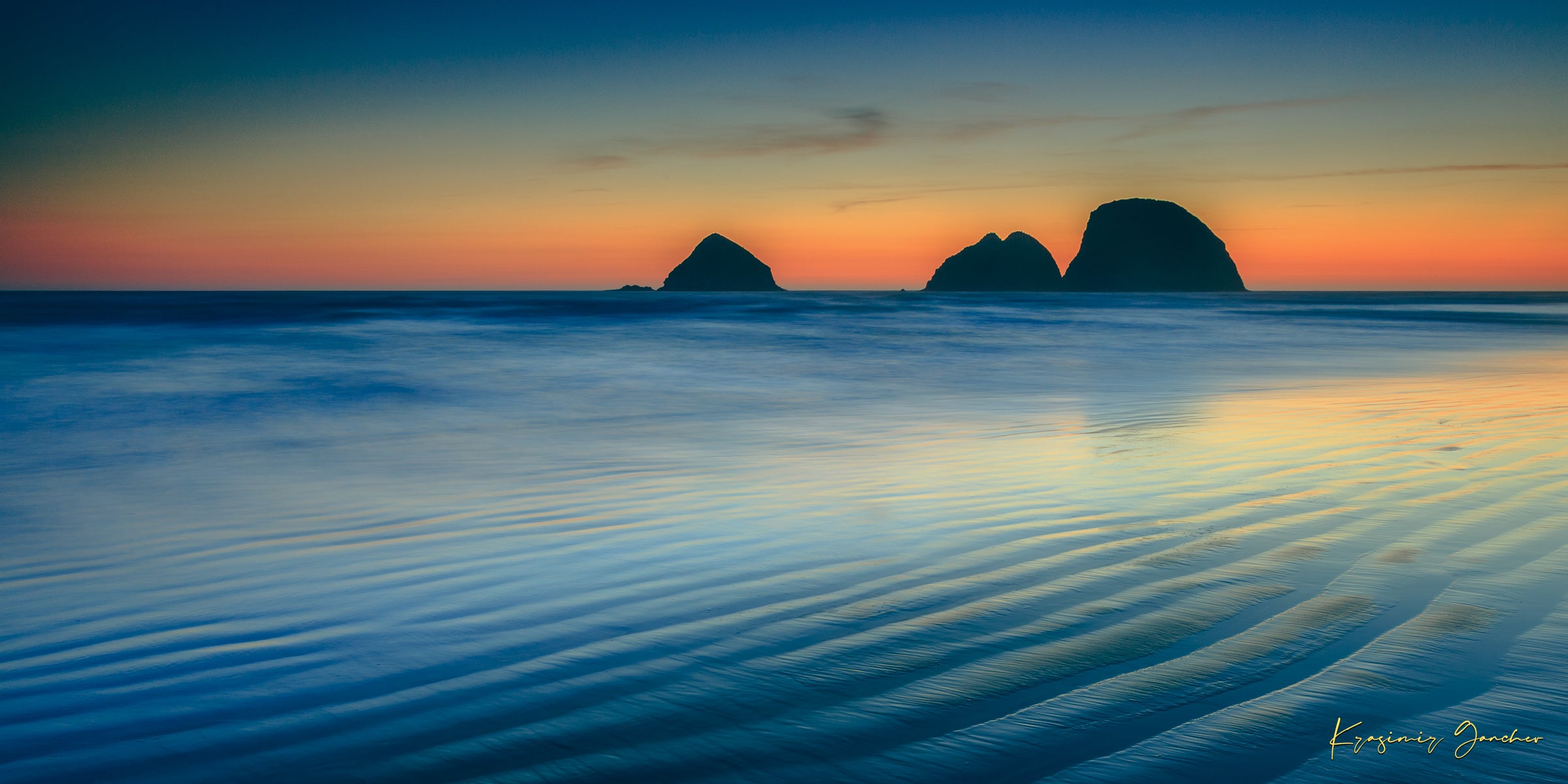 Silhouette of Bird Rock formations against a hazy twilight sky along Canon Beach oceanfront during dusk. #Finish_Acrylic Recess