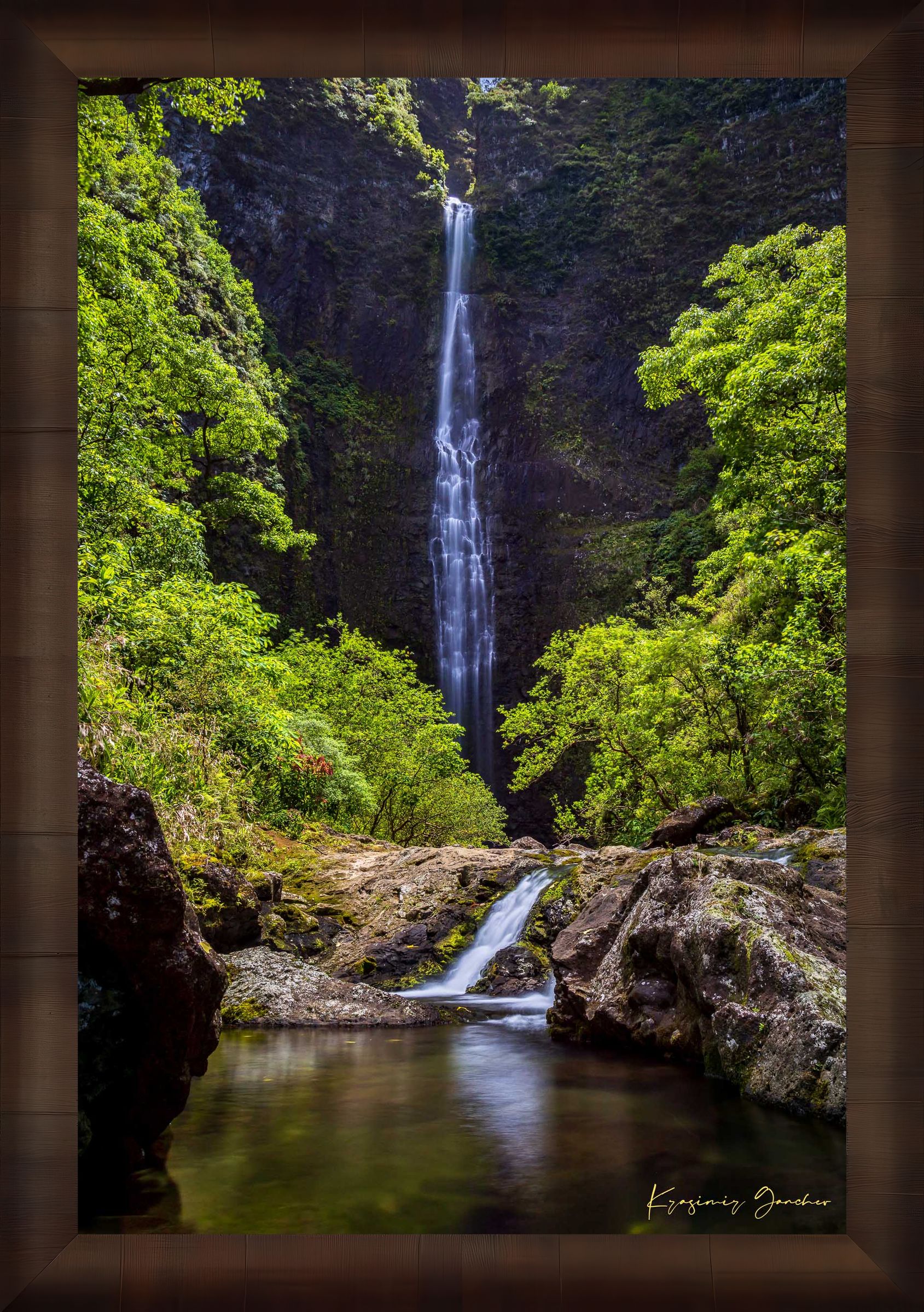 Small waterfall veiled in mist beneath dense foliage at Hanakapiai Falls, Kauai, lit by daylight. #Finish_Roma Cigar Leaf Frame