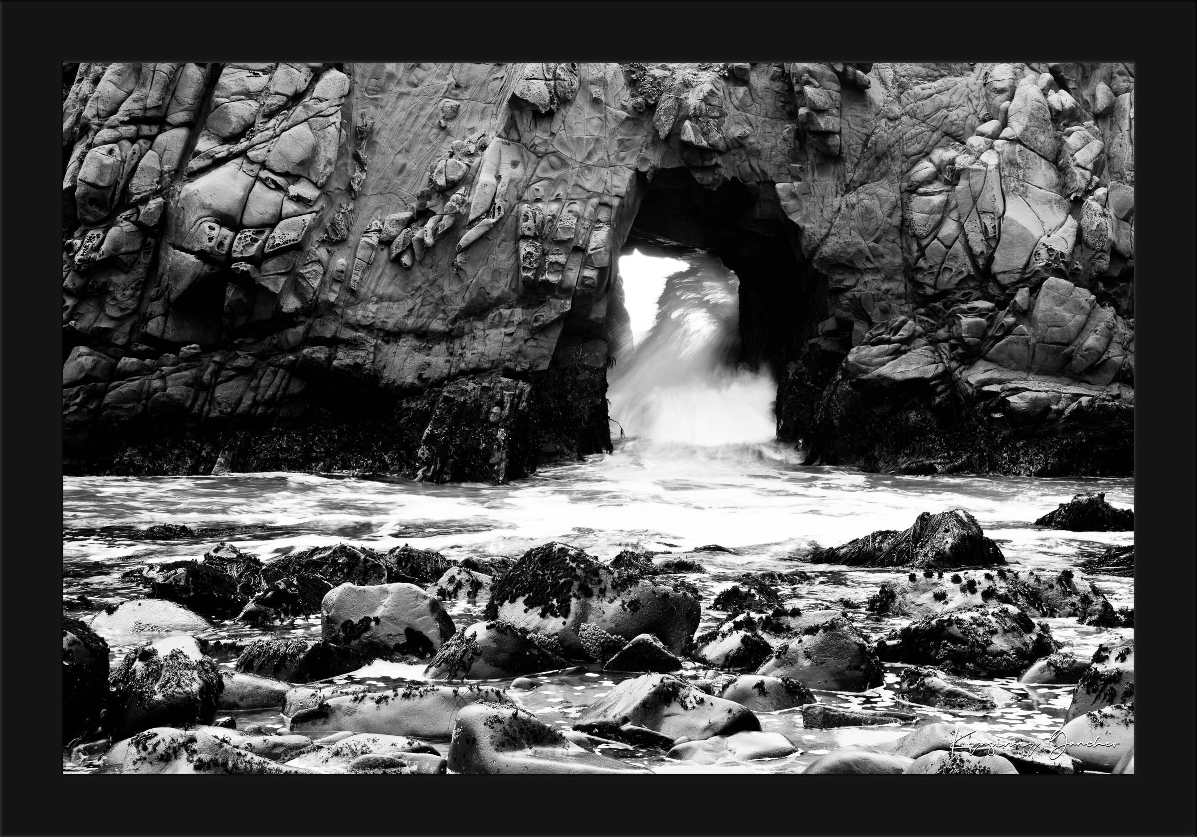 Natural arch formation at Big Sur viewed during daylight, facing the ocean with wave motion. #Finish_Roma Satin Black Frame
