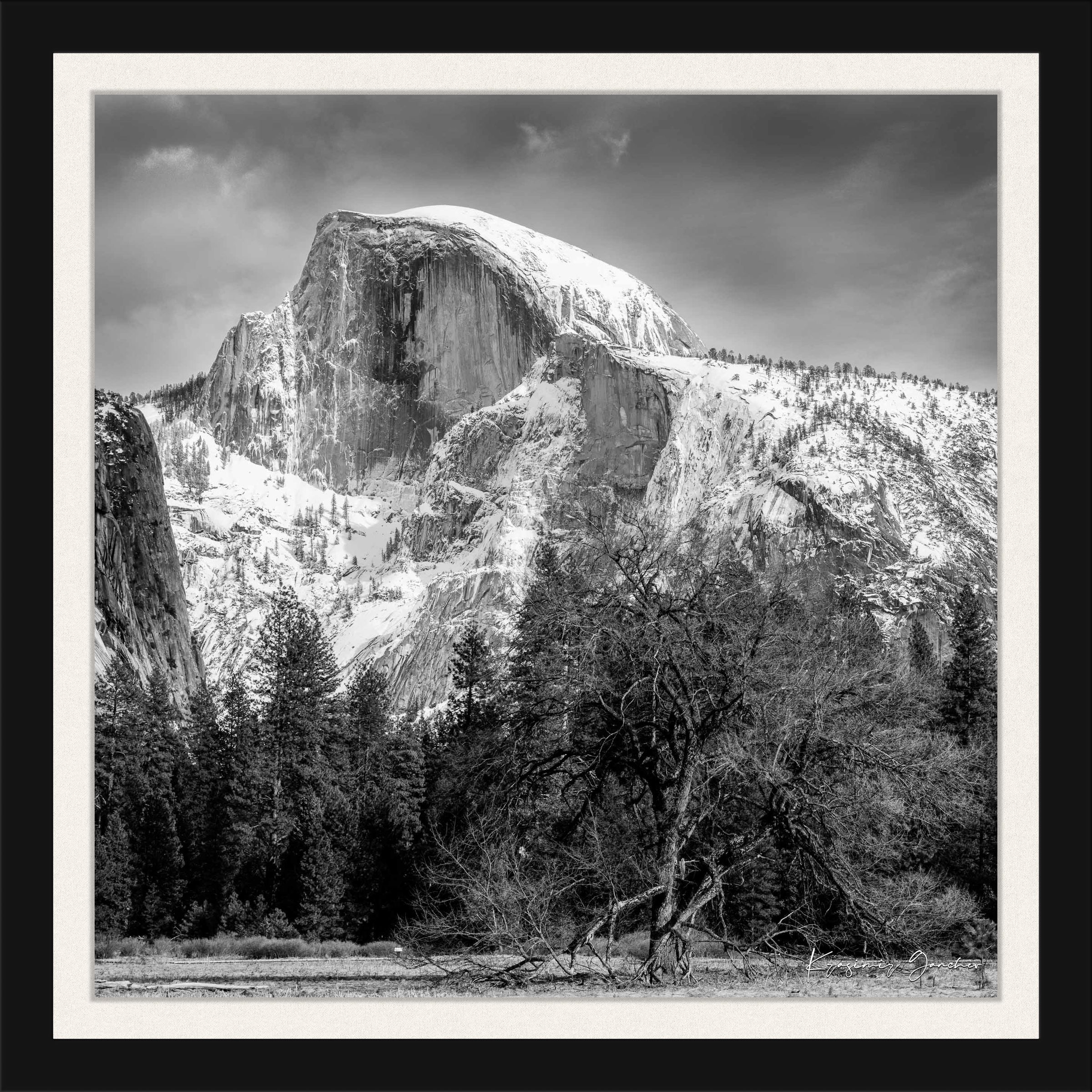 Monolithic Half Dome stands in stark contrast against a shadowed foreground amid clouds and fresh snow in Yosemite National Park. #Finish_Roma Satin Black Frame & Bright Liner