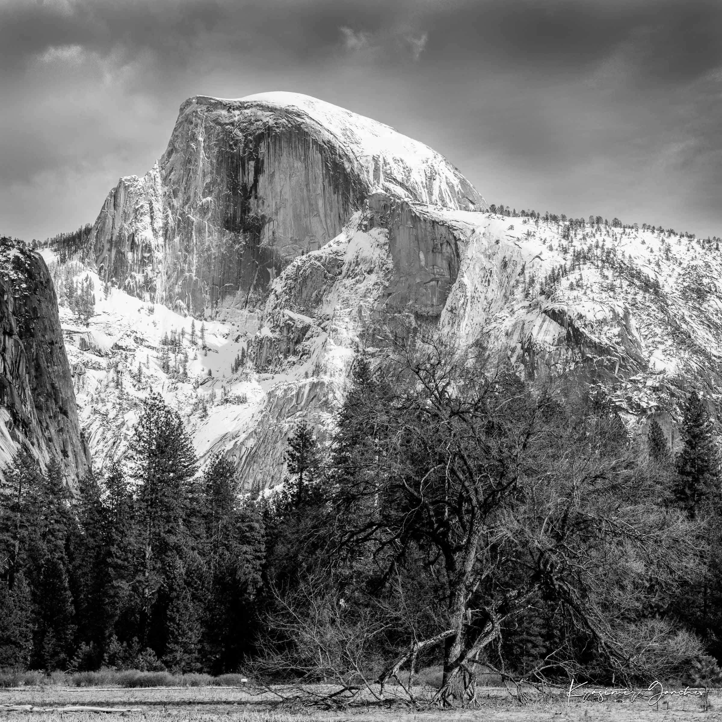 Monolithic Half Dome stands in stark contrast against a shadowed foreground amid clouds and fresh snow in Yosemite National Park. #Finish_Acrylic Recess