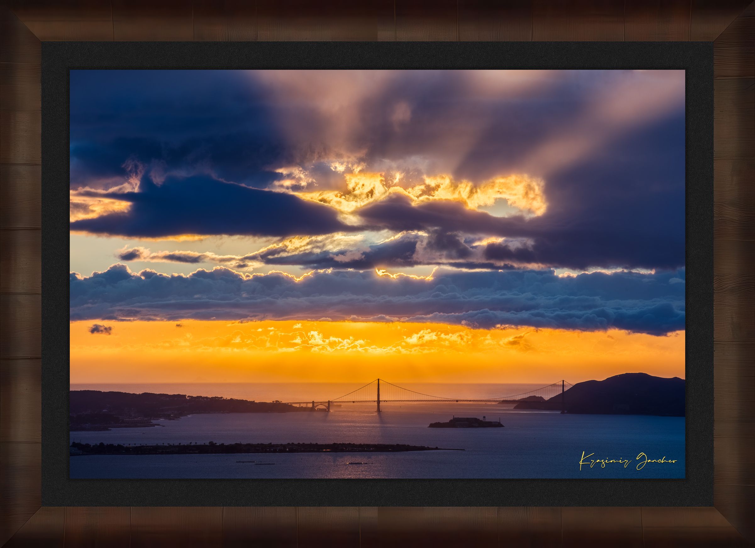 Golden Gate Bridge spanning a sunlit bay at sunset under layered stormy clouds, warm hues blending into cool sky tones. #Finish_Roma Cigar Leaf Frame & Dark Liner