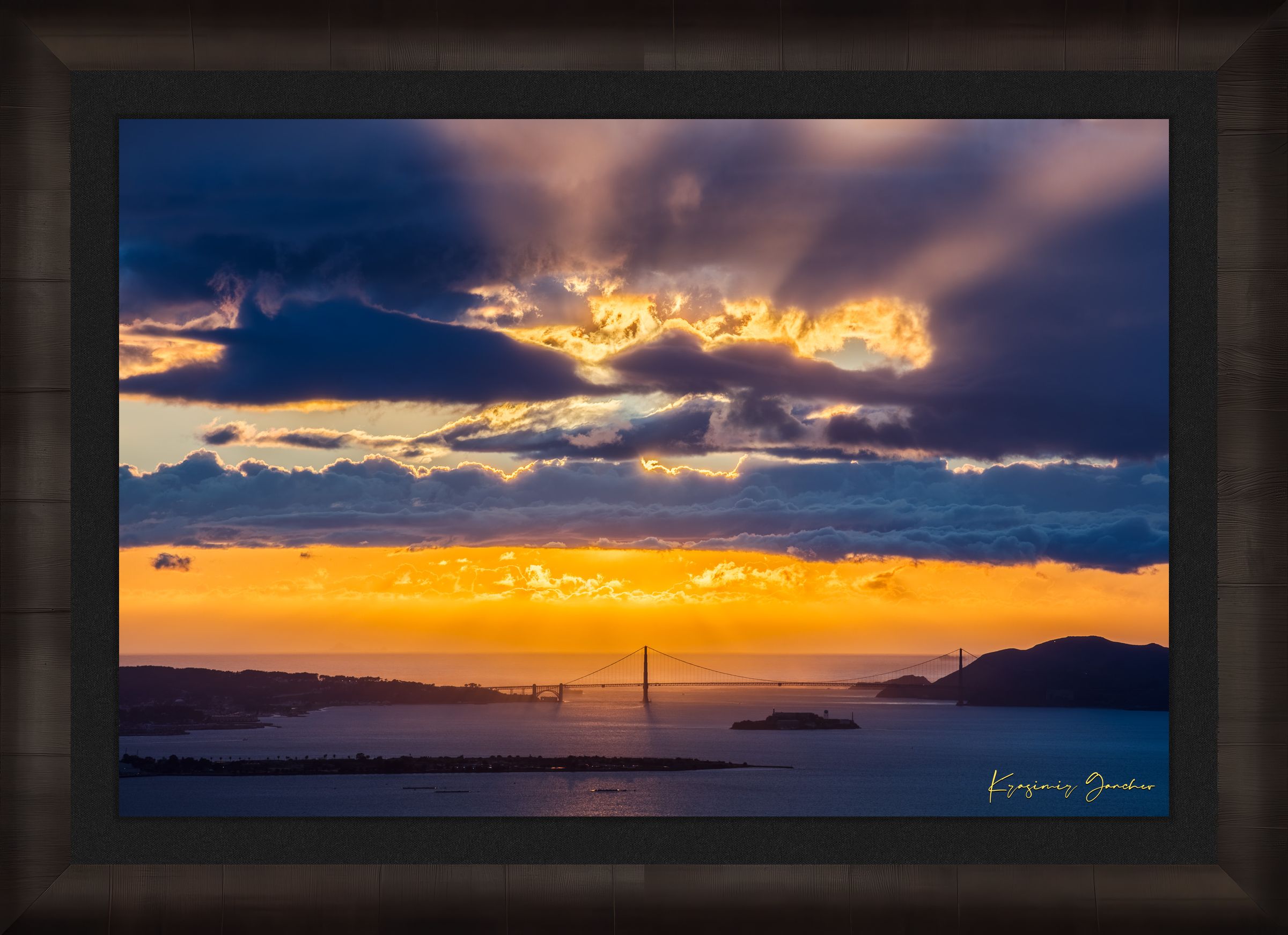 Golden Gate Bridge spanning a sunlit bay at sunset under layered stormy clouds, warm hues blending into cool sky tones. #Finish_Roma Dark Ash Frame & Dark Liner