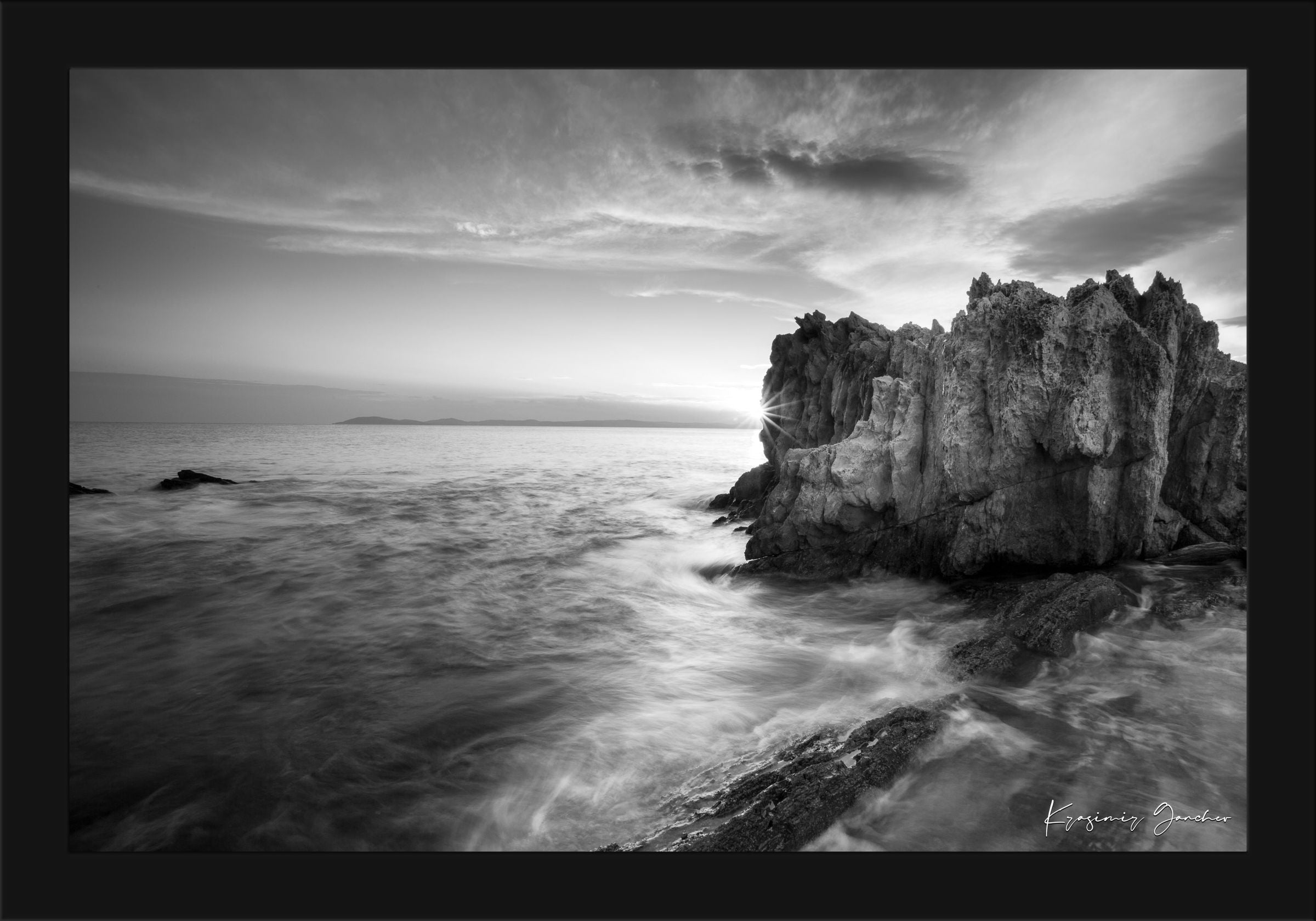 Black and white photograph of Sithonia’s rugged coastal cliffs during sunset, high contrast with breaking waves. #Finish_Roma Satin Black Frame