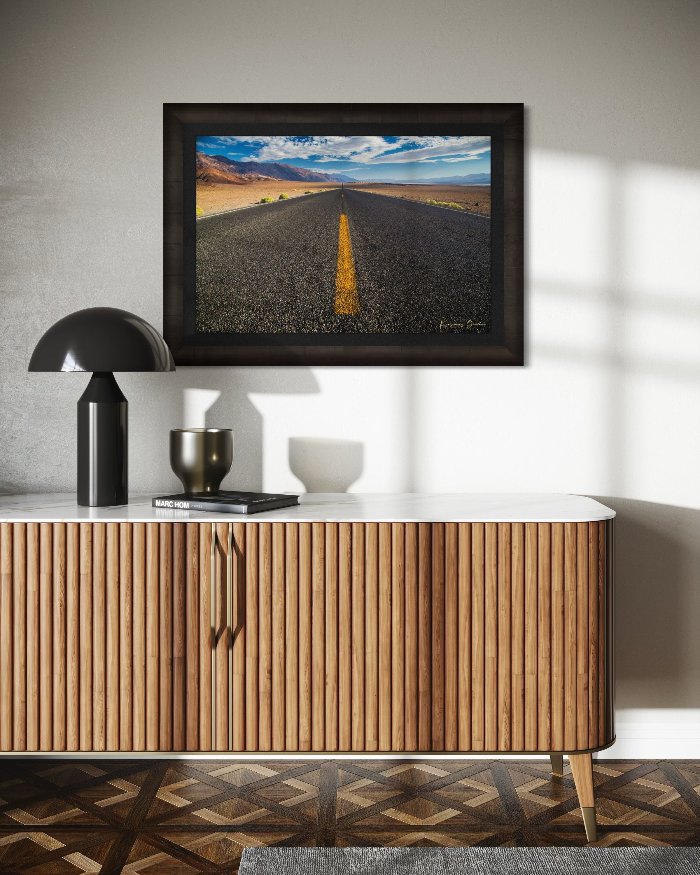 Straight desert road stretching into an open landscape of arid terrain in Death Valley National Park under overcast skies. #Finish_Roma Dark Ash Frame & Dark Liner