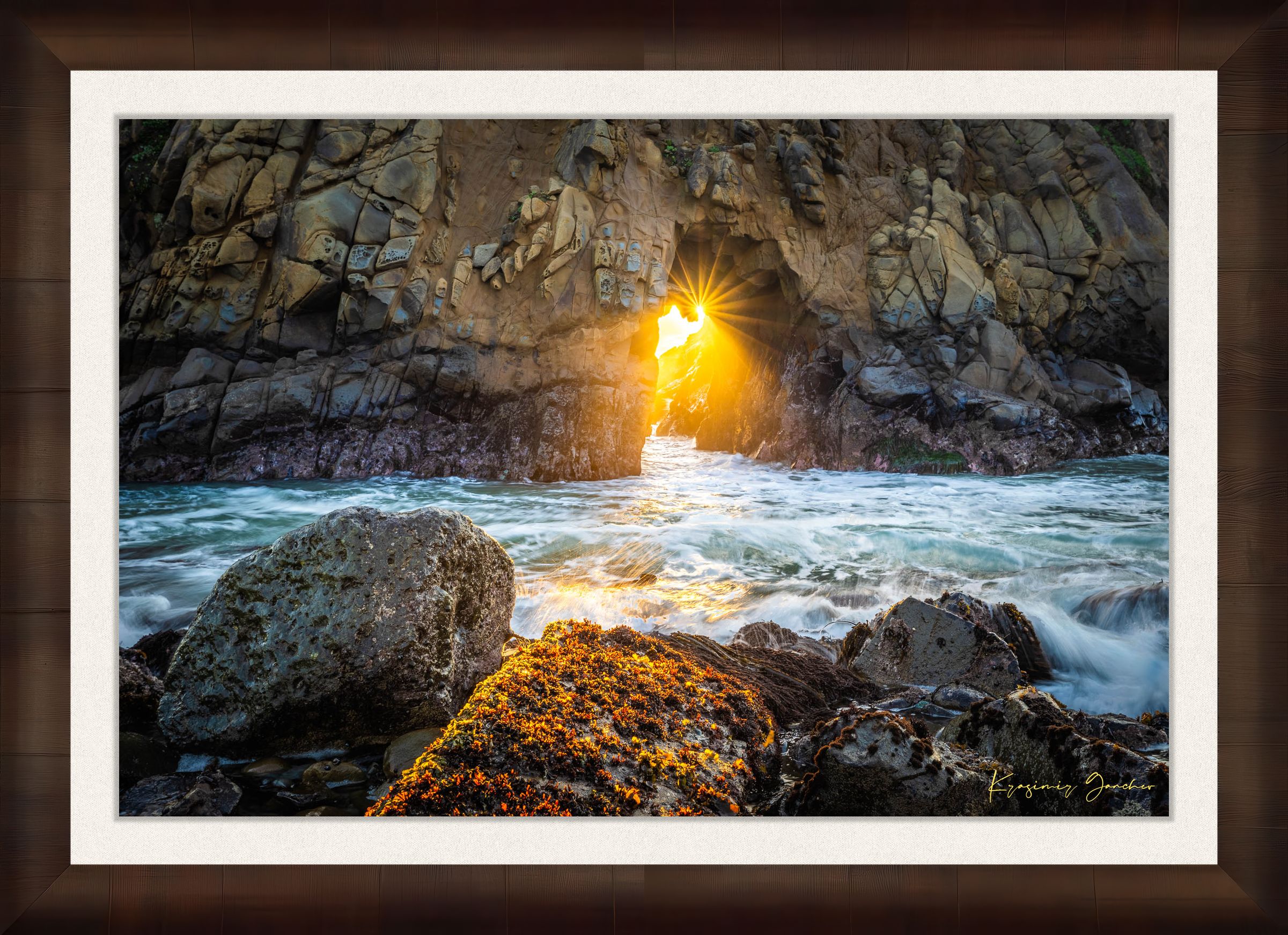 Golden-hour photograph of a coastal arch formed by erosion at Big Sur's rugged shoreline, featuring boulders and open sea. #Finish_Roma Cigar Leaf Frame & Bright Liner