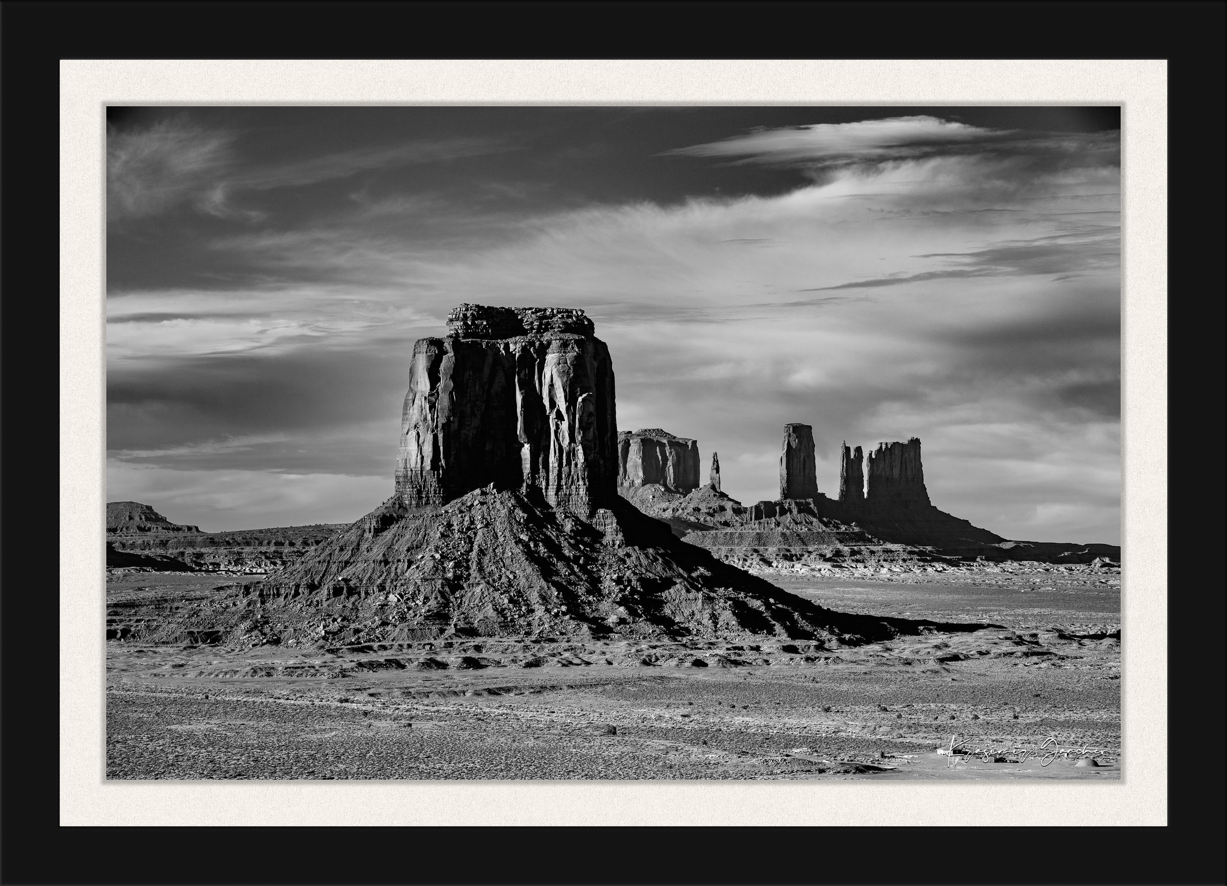 Timeless black and white landscape of Monument Valley's towering formations under dawn skies with soft cloud cover. #Finish_Roma Satin Black Frame & Bright Liner
