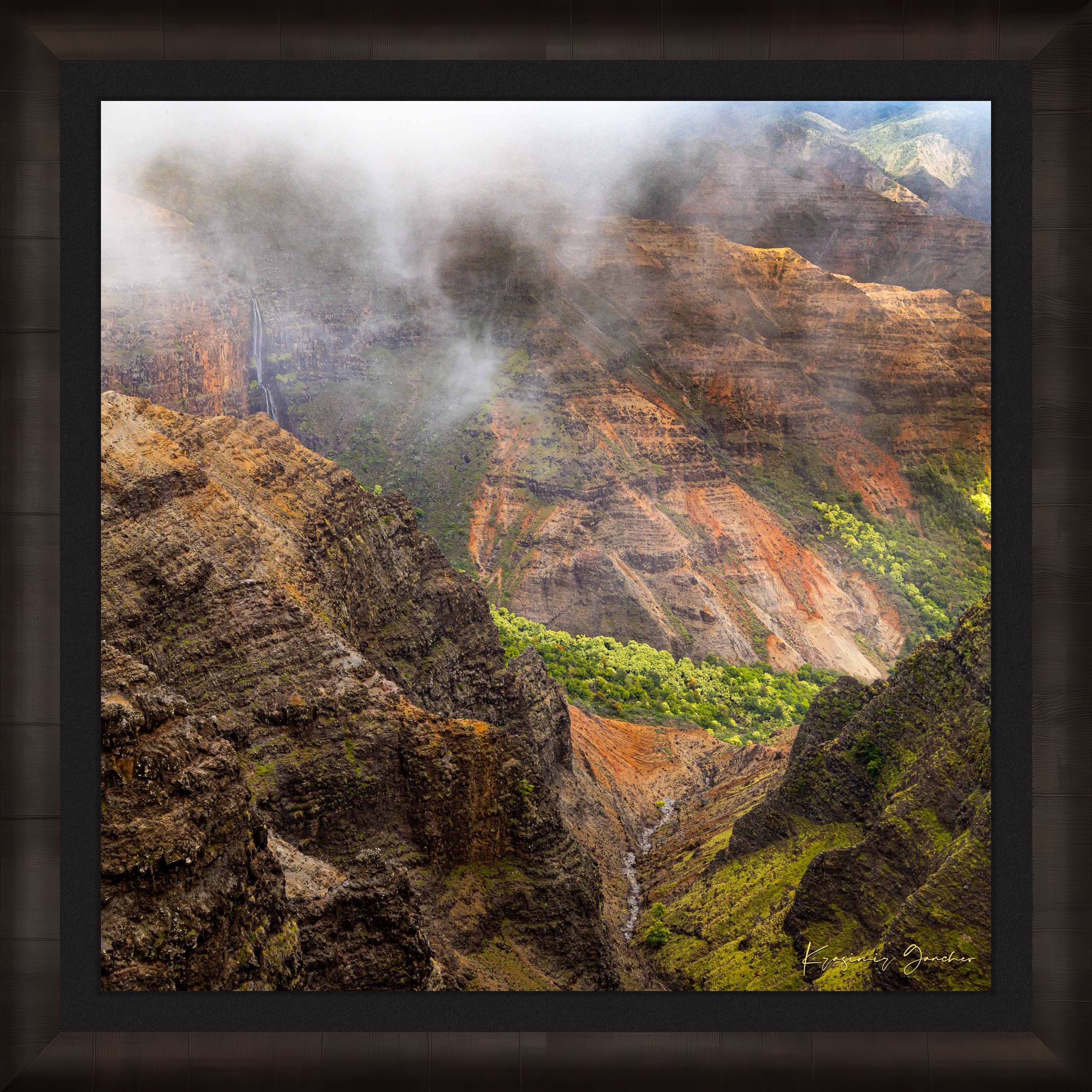Waterfall descending into Waimea Canyon on Kauai, mist rising through dense foliage in foggy conditions. #Finish_Roma Dark Ash Frame & Dark Liner